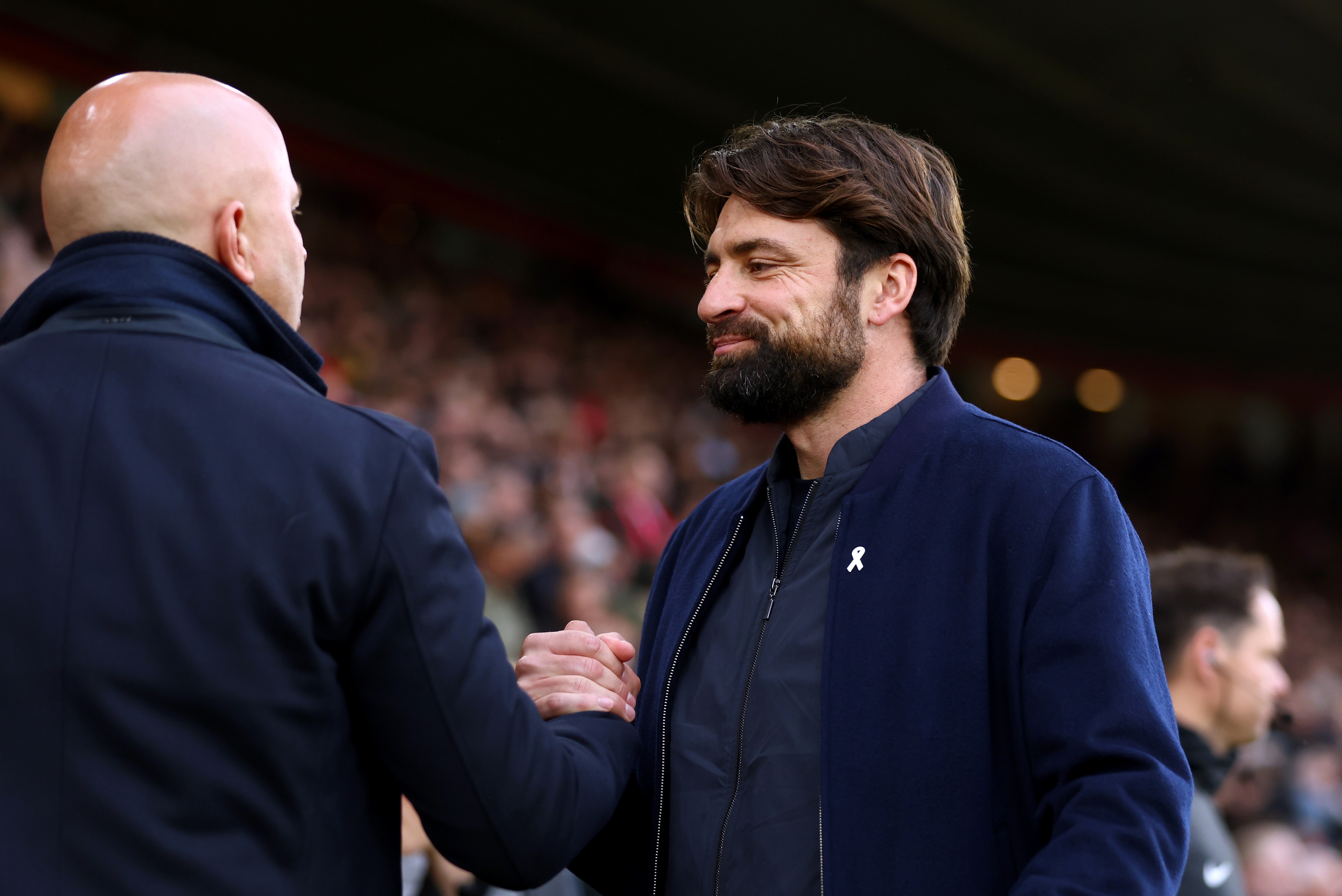 Southampton boss Russell Martin greets Liverpool head coach Arne Slot ahead of Premier League clash.