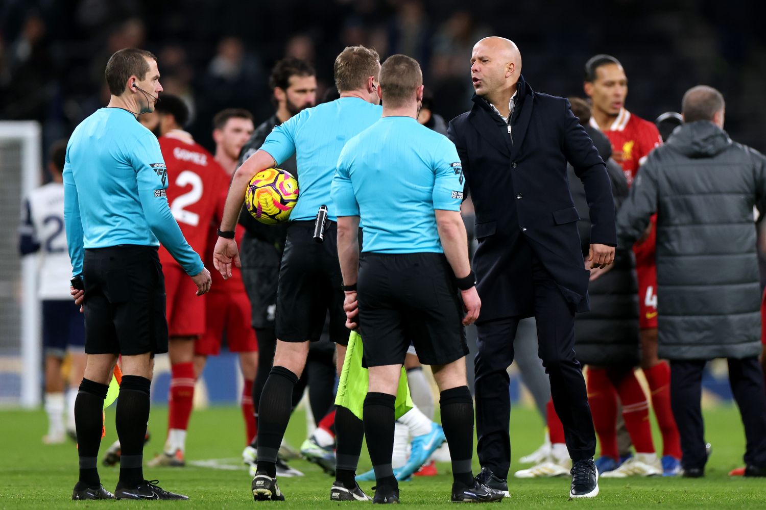 Arne Slot shakes hands with officials after beating Tottenham