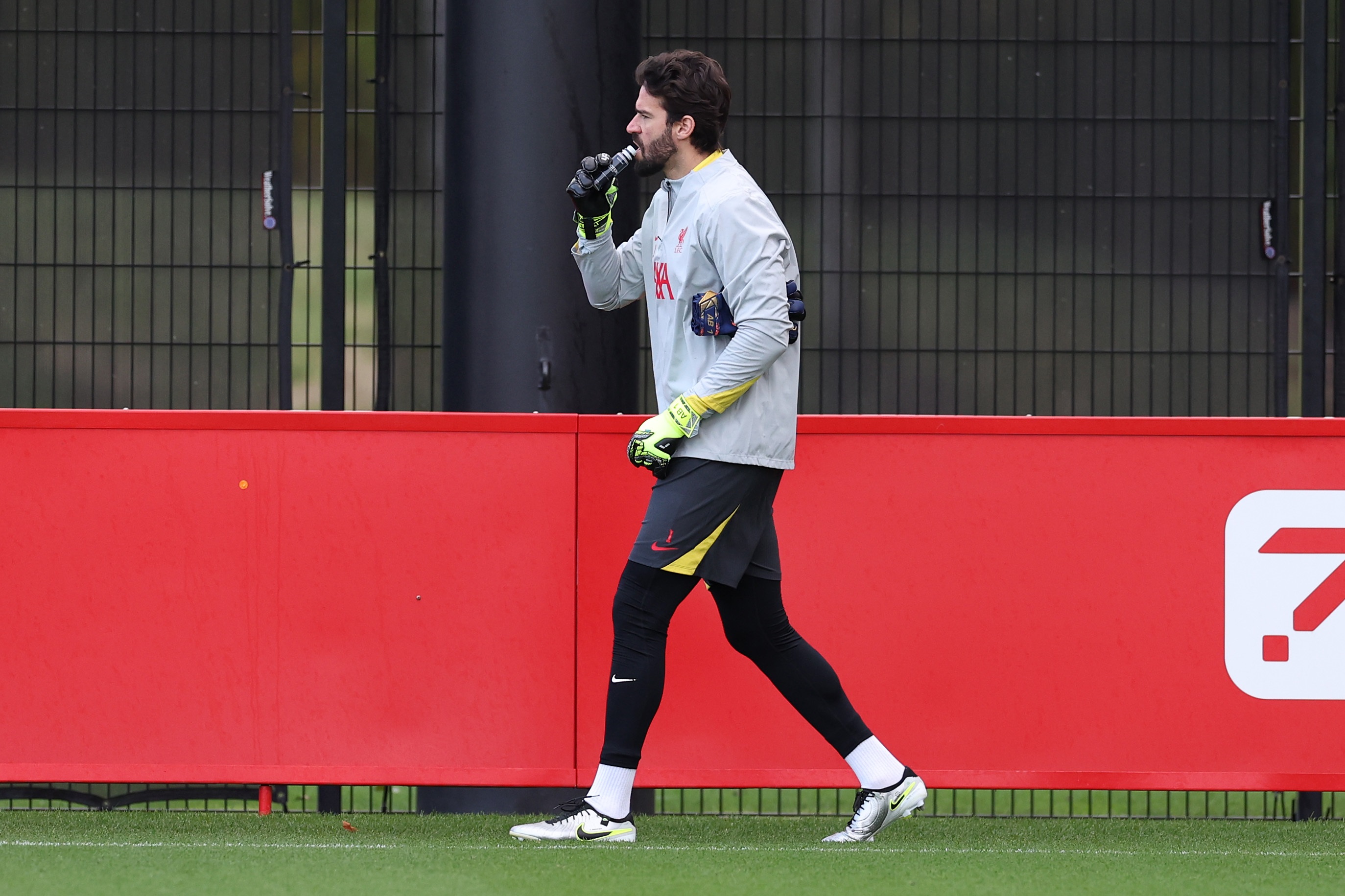 Alisson Becker takes a drink during Liverpool team training.