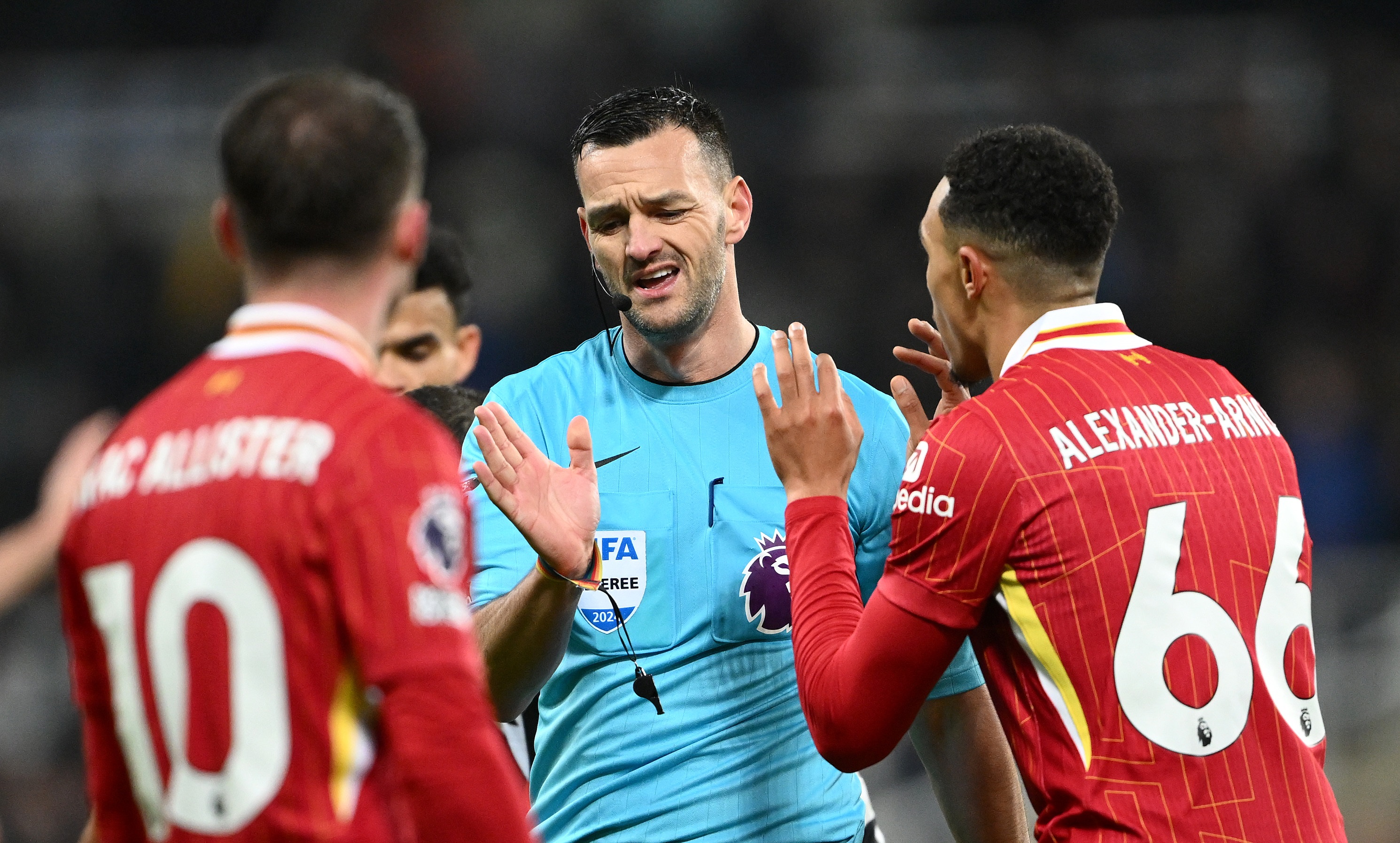 Andy Madley talks to upset Liverpool players.