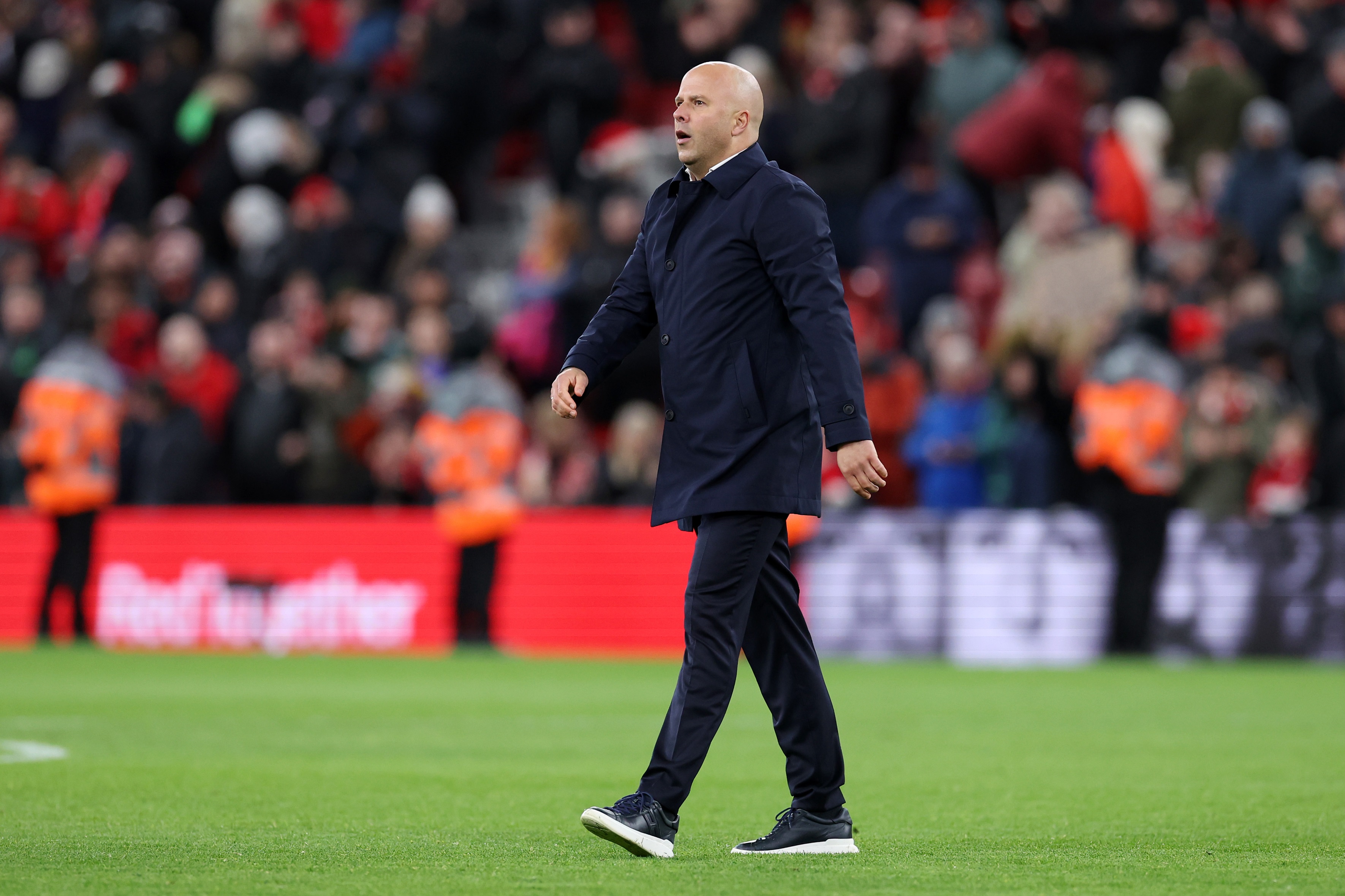 Arne Slot walks on the Anfield pitch following Liverpool's draw with Fulham.