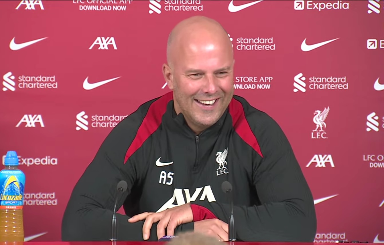A smiling Arne Slot addresses the media.
