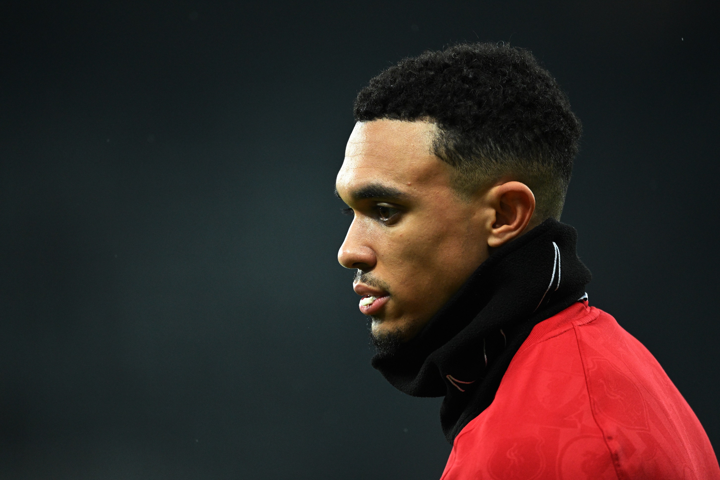 Trent Alexander-Arnold looks thoughtful during warm-up for Newcastle game.