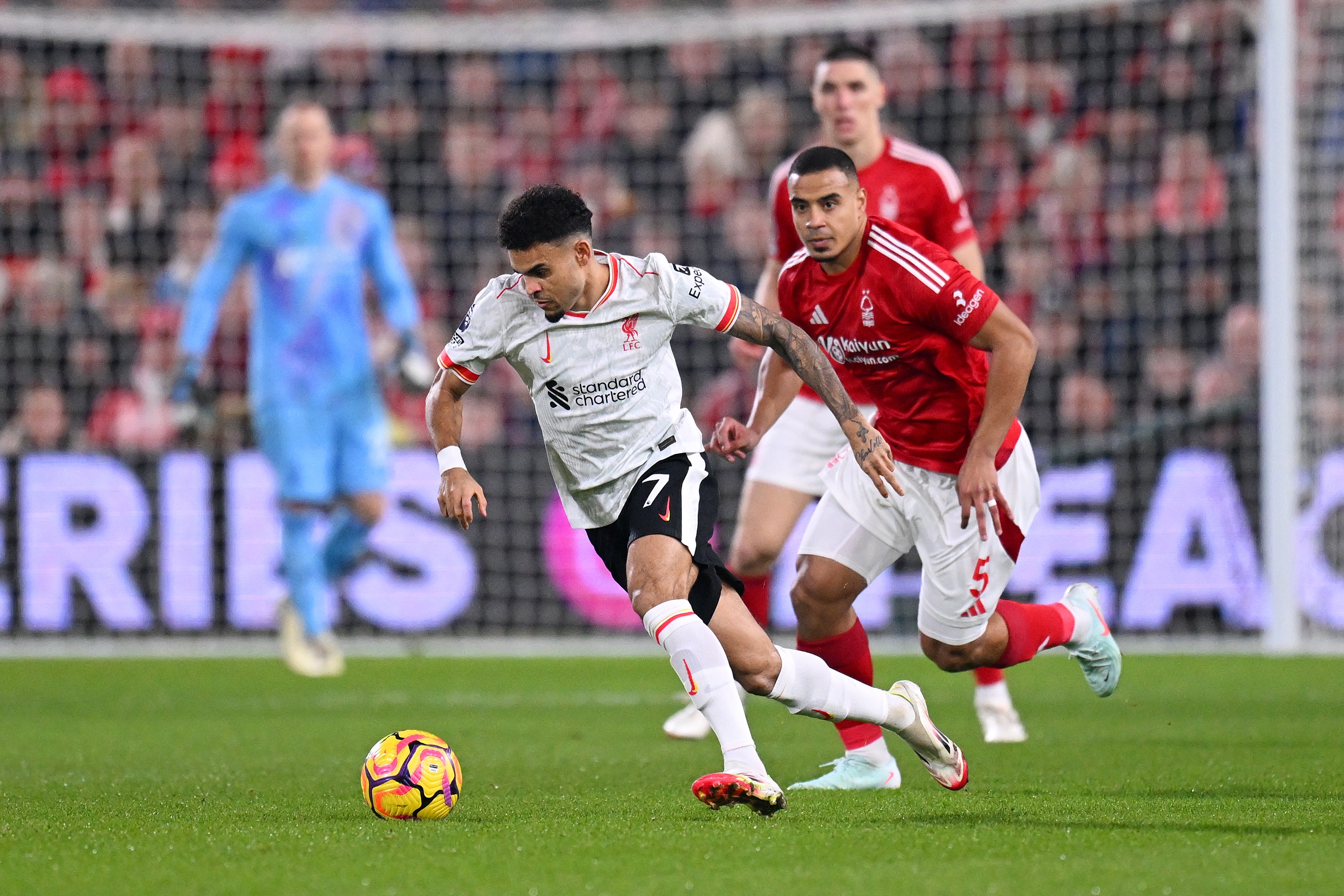Luis Diaz races away with the ball from Murillo.