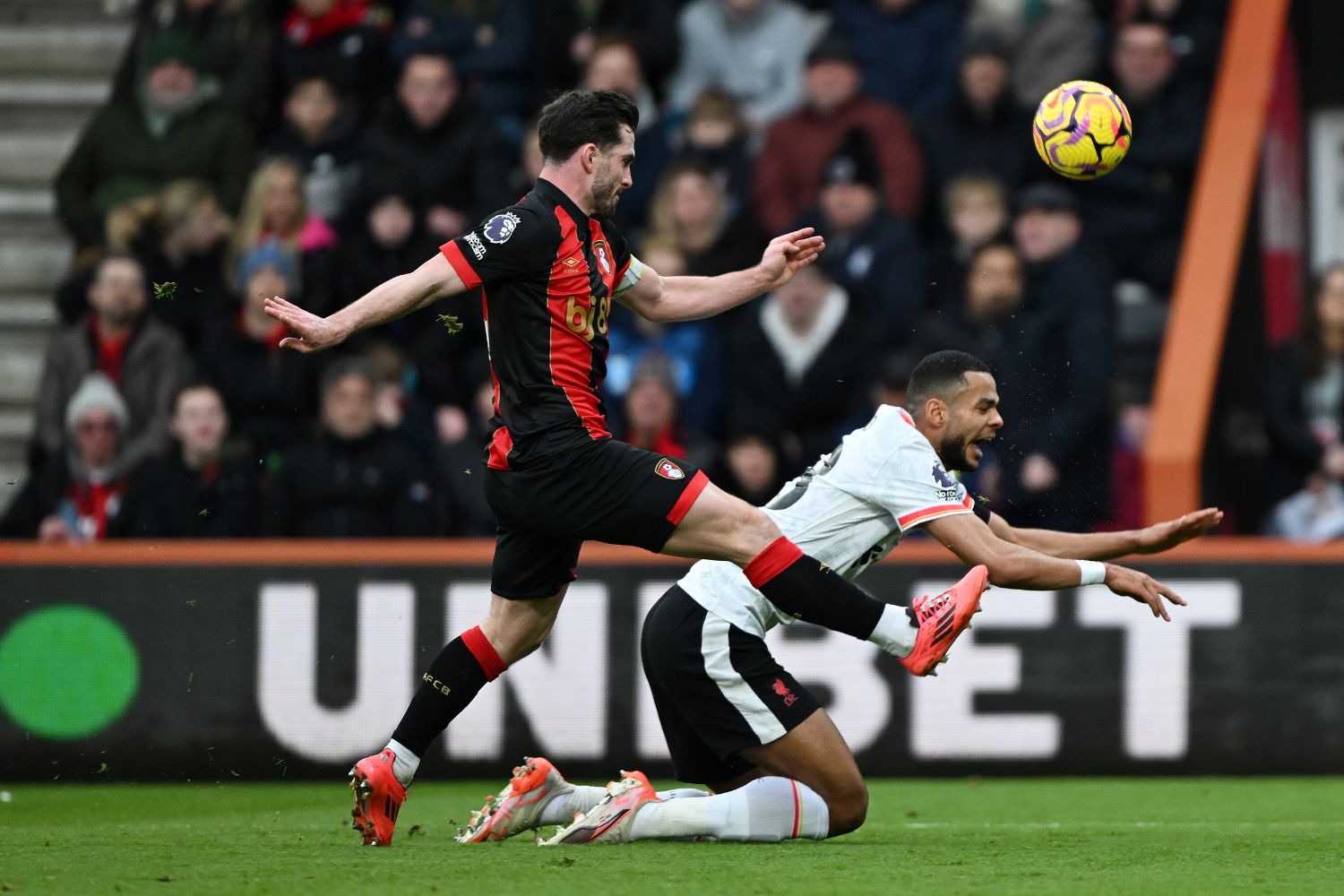 Lewis Cook clears out Cody Gakpo for a penalty