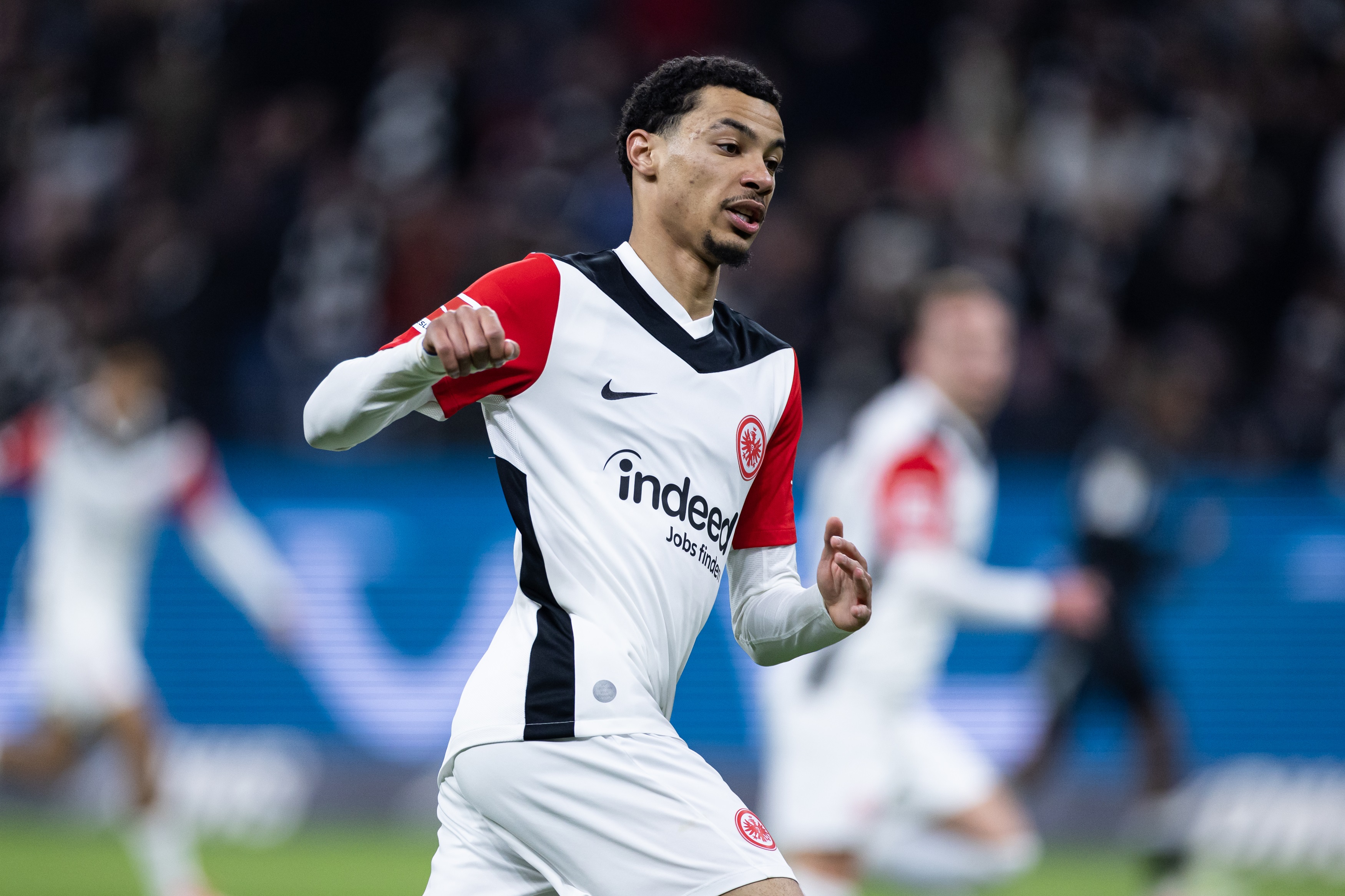 Hugo Ekitike runs on the pitch in a Bundesliga match.