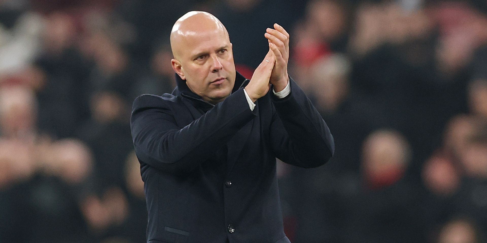 Arne Slot claps Liverpool fans at Anfield