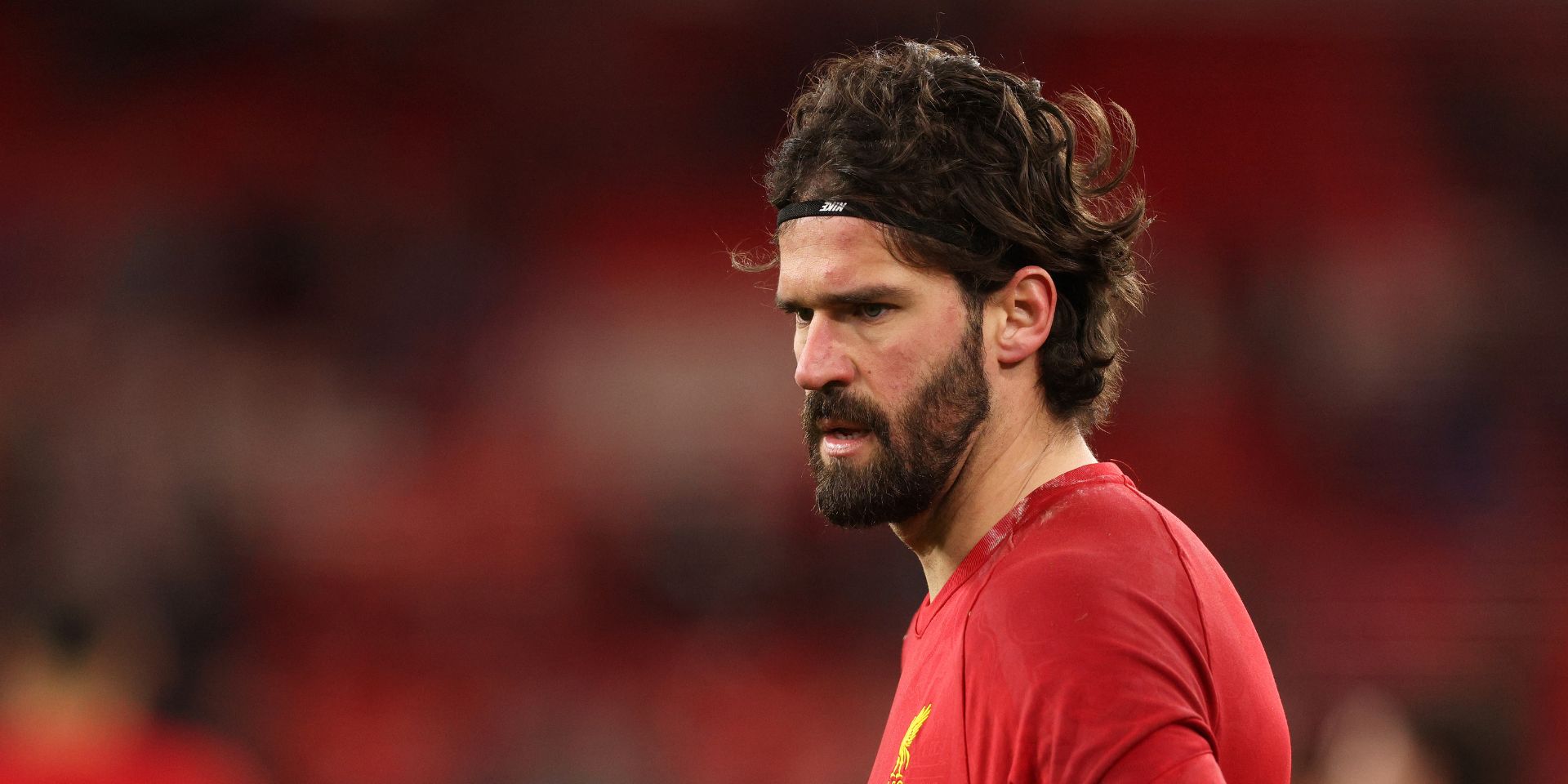 Alisson Becker warms up for Liverpool