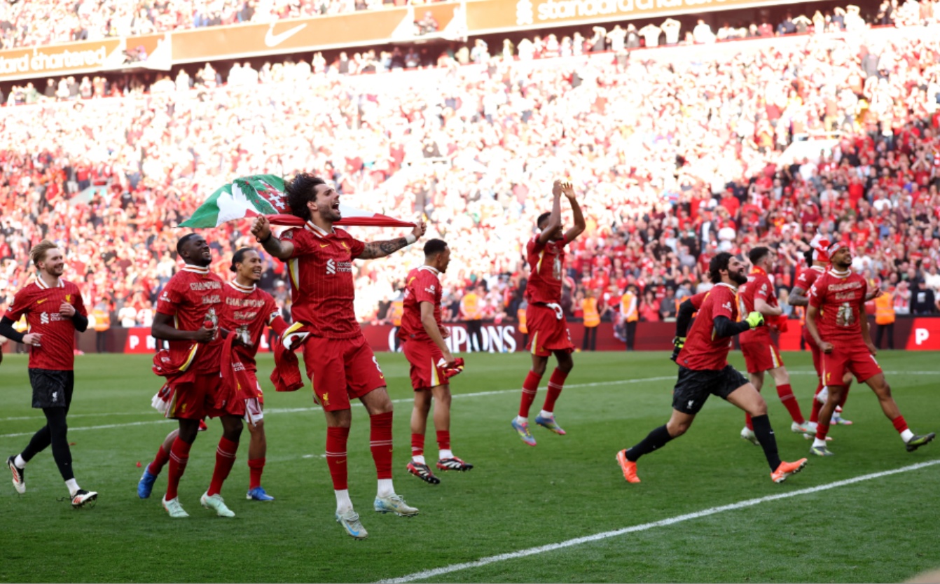 Liverpool players celebrate after winning the Premier League on Sunday