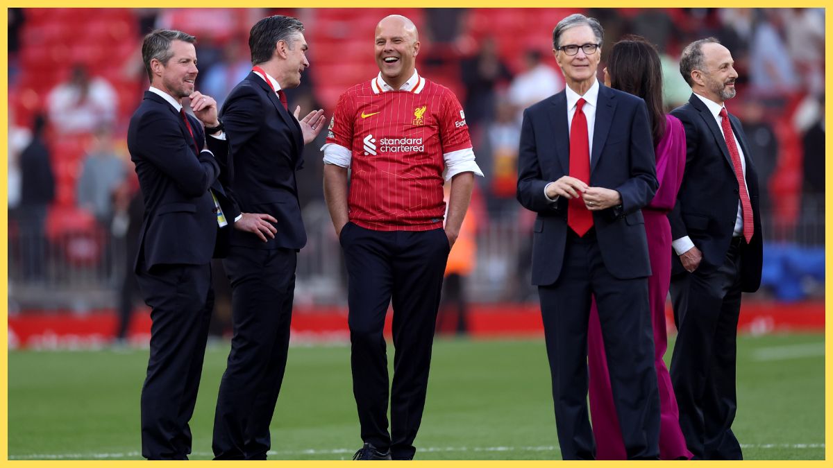 Arne Slot smiles talking to Liverpool sporting director Richard Hughes.