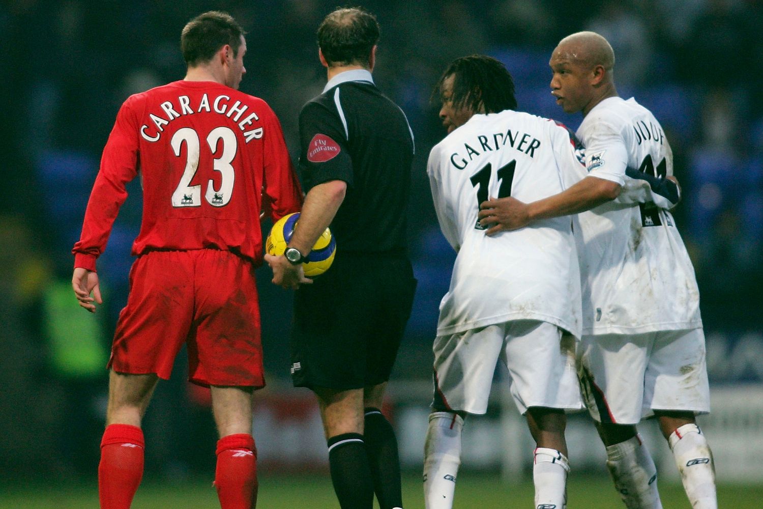 El-Hadji Diouf (right) of Bolton is kept apart from Jamie Carragher of Liverpool