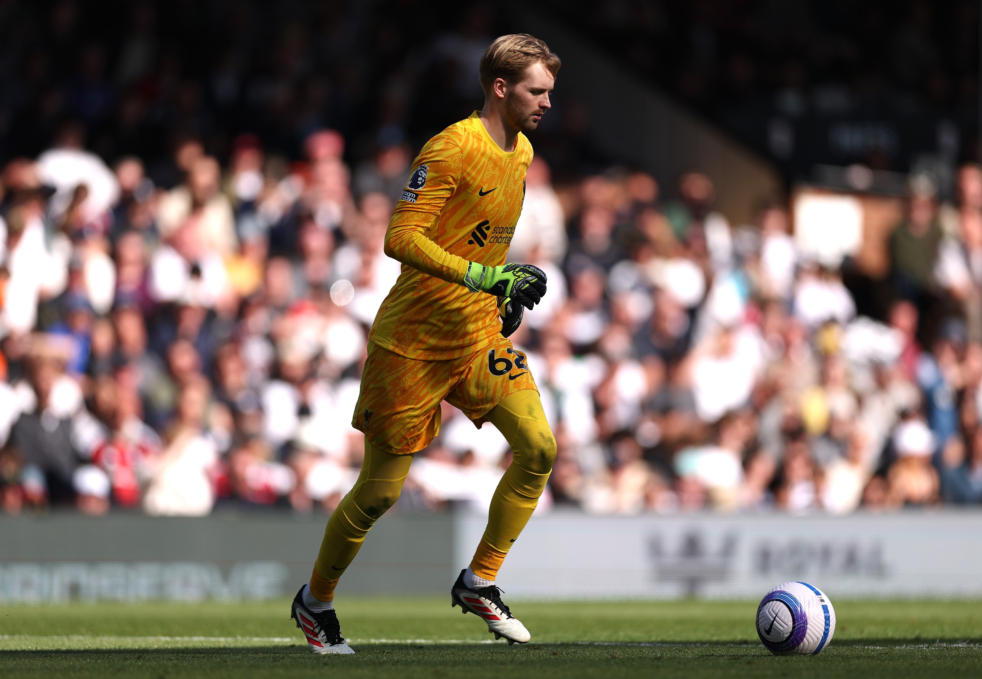 Caoimhin Kelleher runs with the ball during Liverpool game.