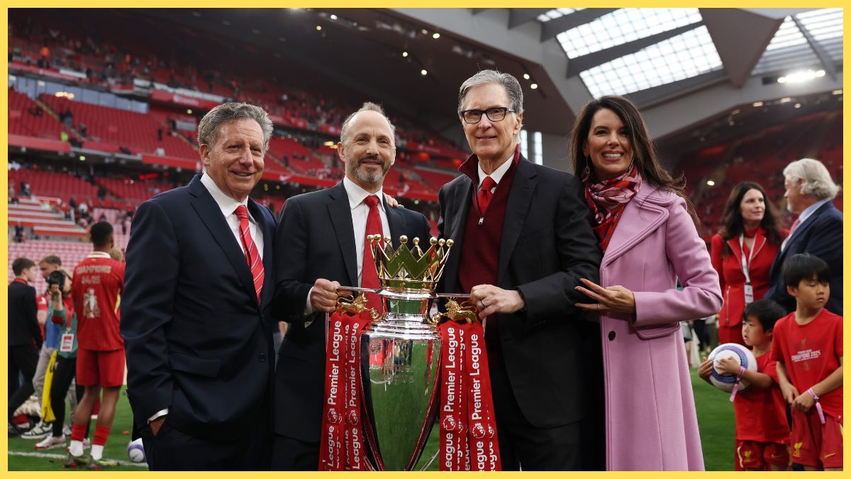 Liverpool owner John W Henry holds the Premier League trophy with Mike Gordon.