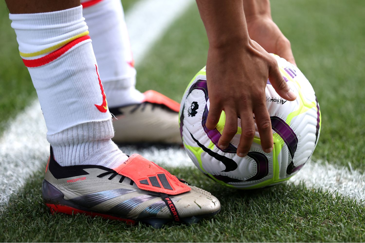 Liverpool player with Adidas boots and a Nike ball