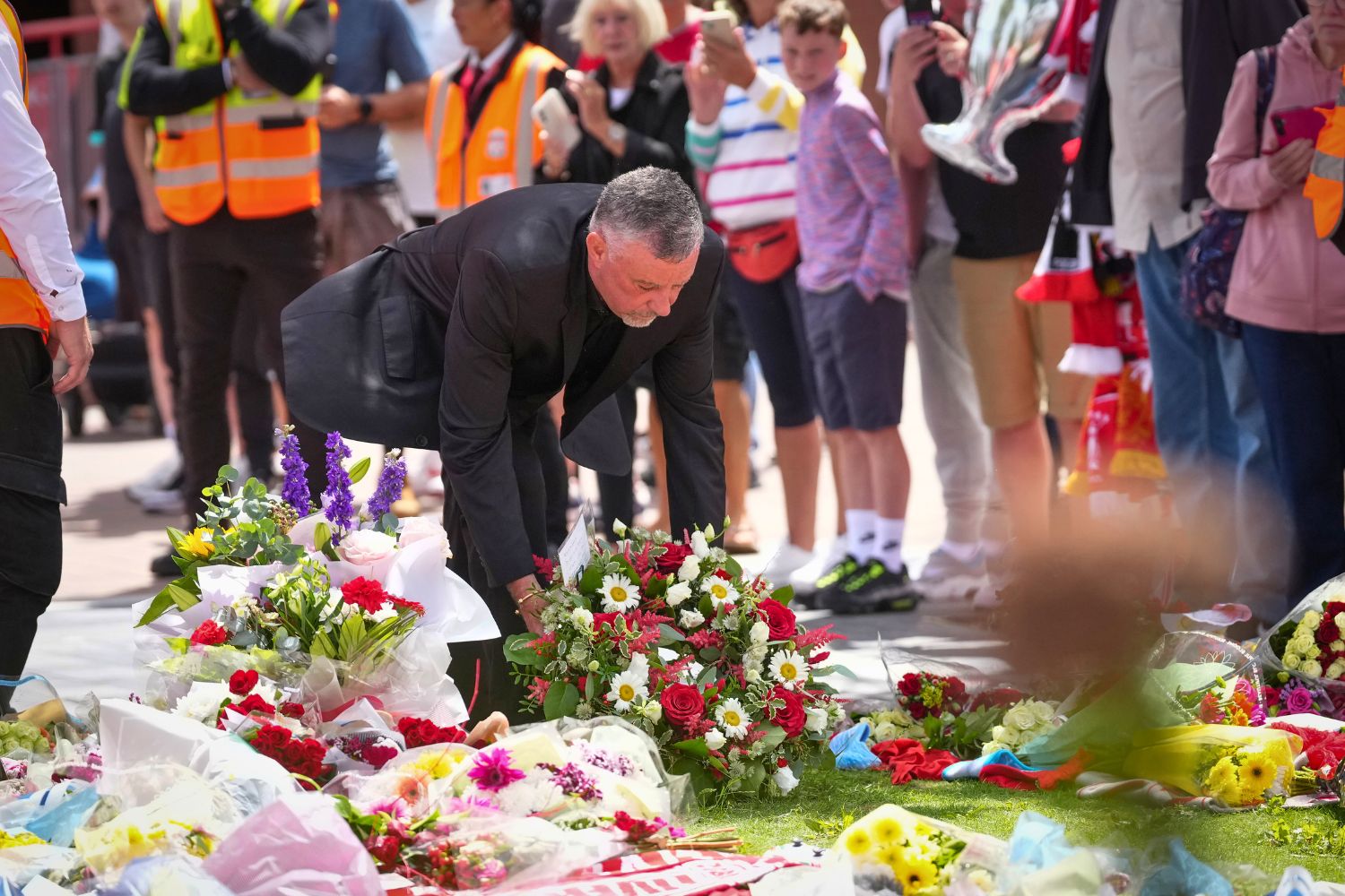 John Aldridge lays flowers at Jota mural