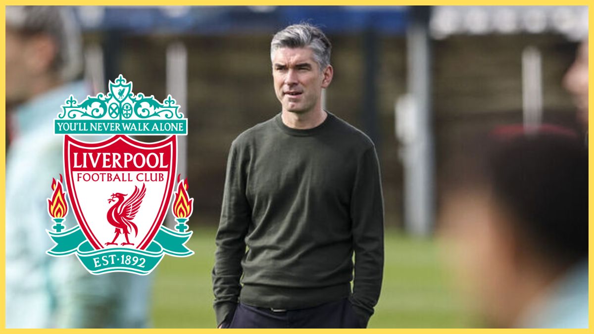 Richard Hughes stands with his hands in his pockets next to Liverpool club crest.