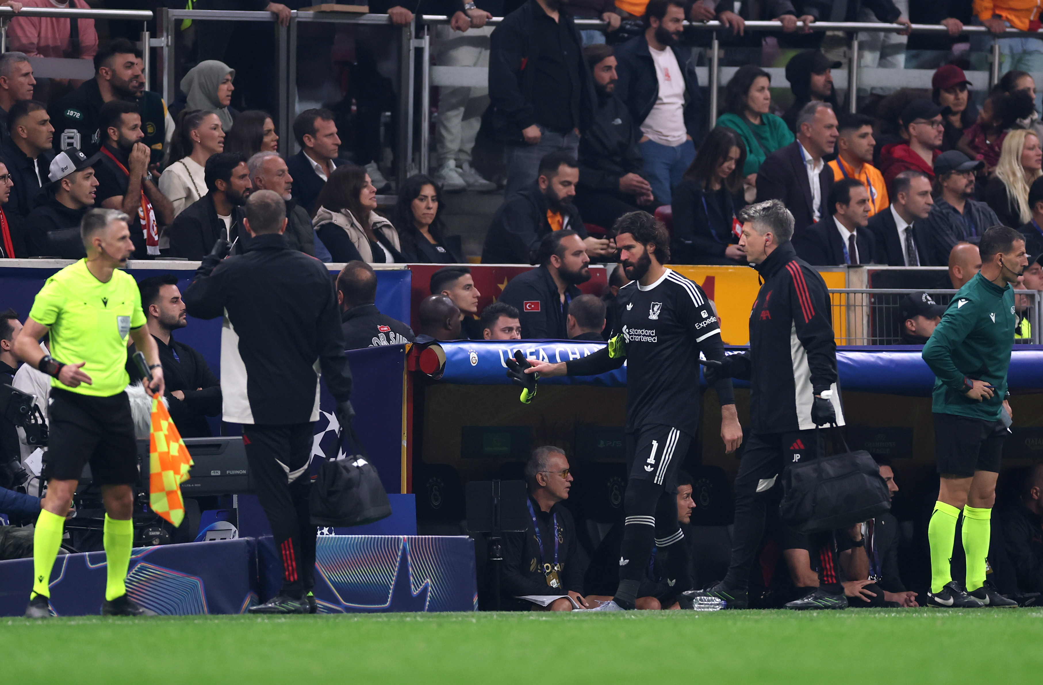 Alisson Becker leaves the pitch injured against Galatasaray