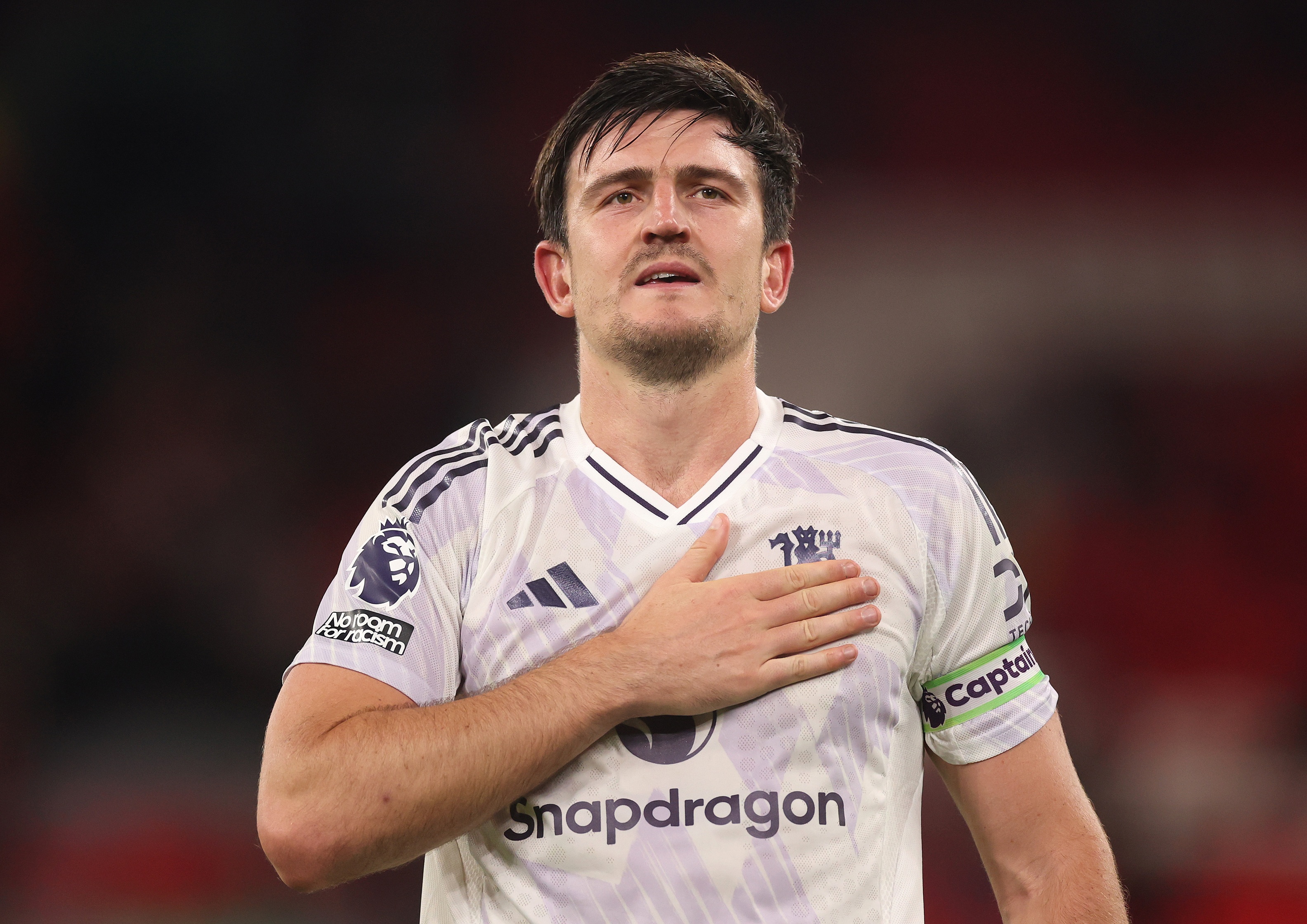 Harry Maguire puts his hand on his chest.