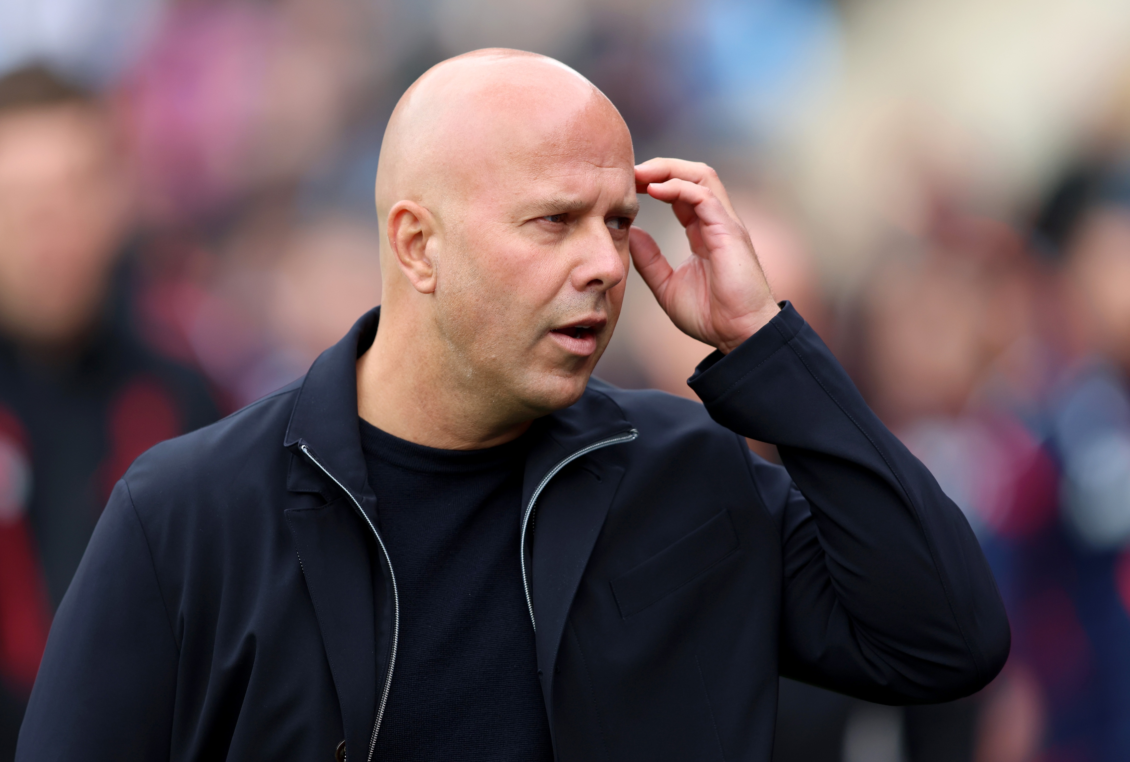 Liverpool head coach Arne Slot scratches his head.