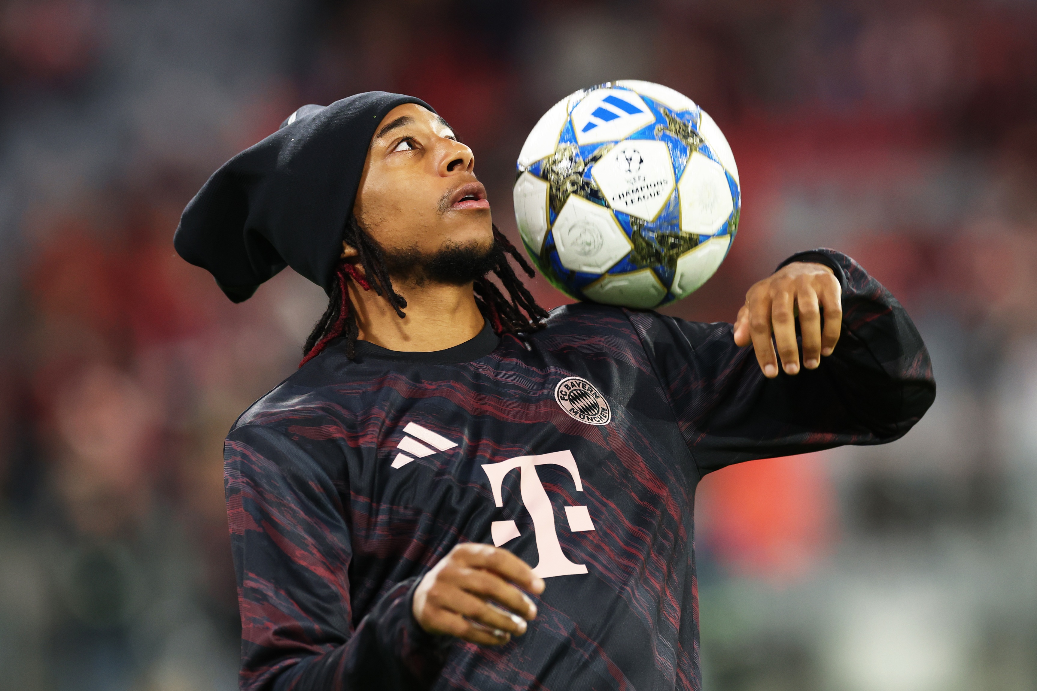 Michael Olise controls a football with his shoulder.