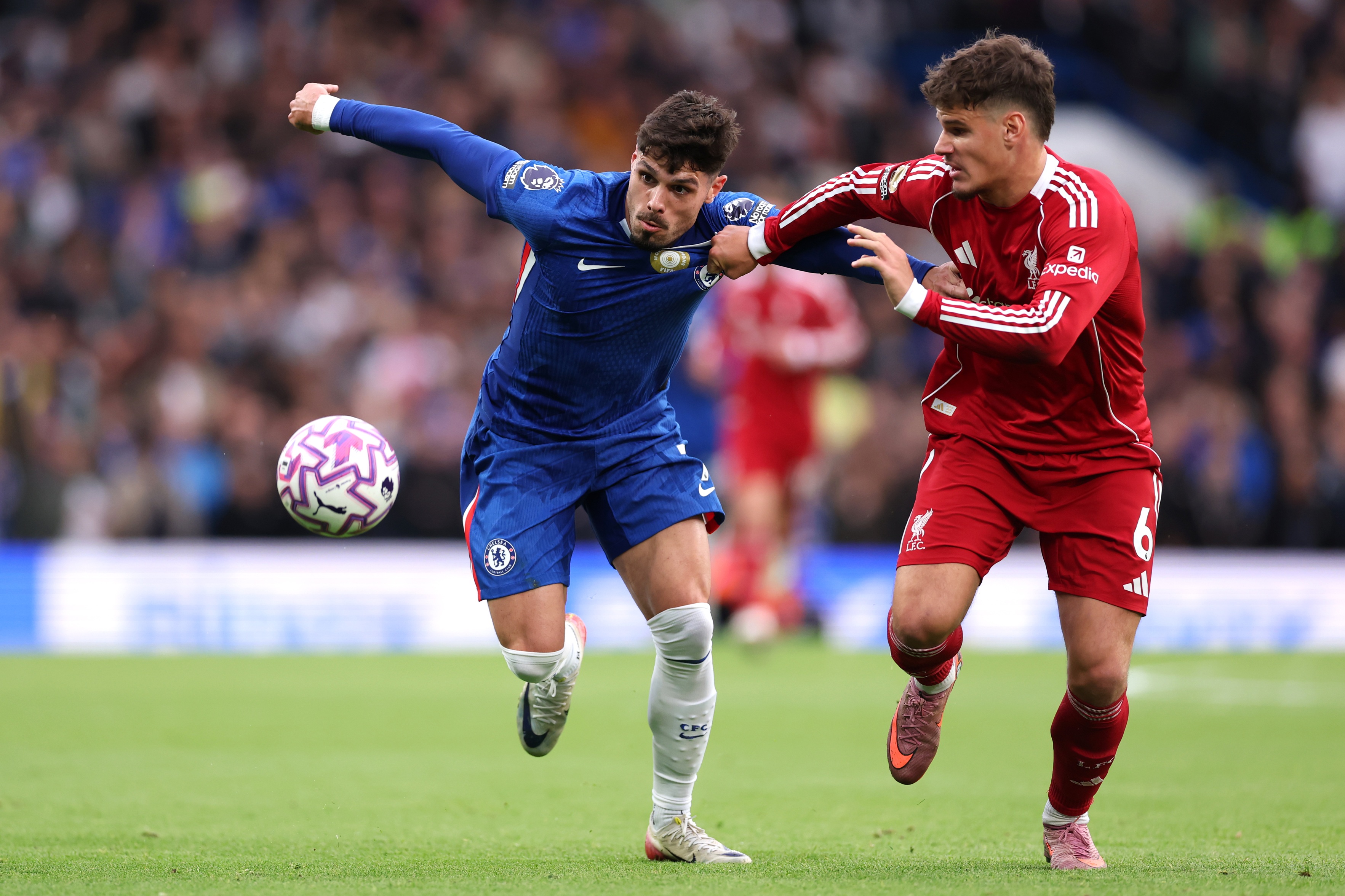 Milos Kerkez grapples with Chelsea's Pedro Neto.