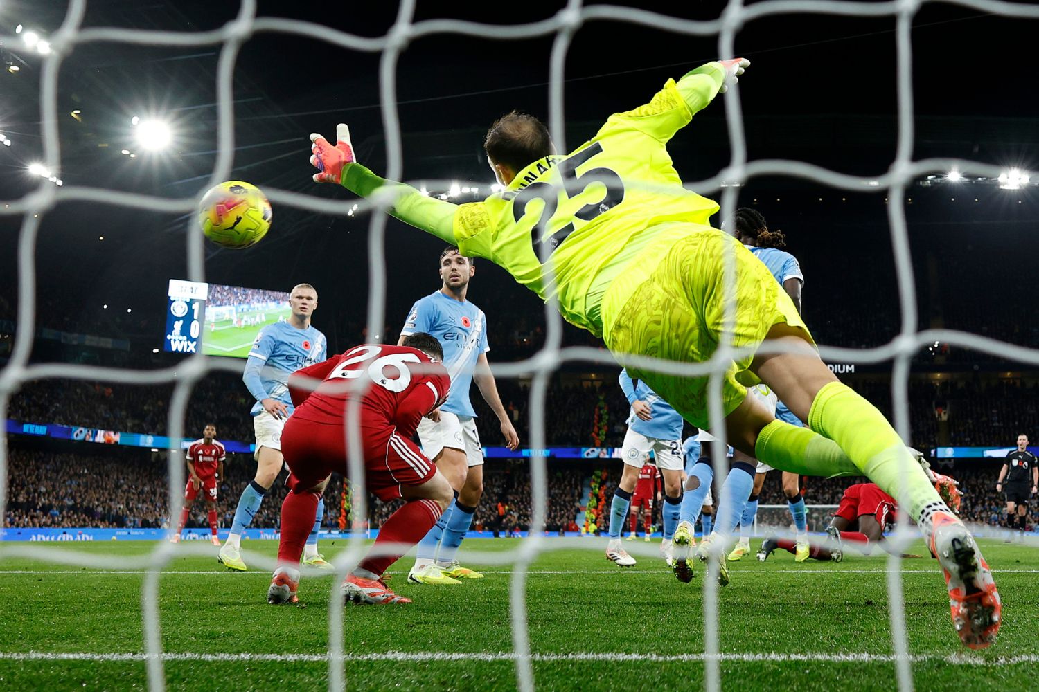 Virgil van Dijk of Liverpool scores a goal past Gianluigi Donnarumma of Manchester City as Andrew Robertson of Liverpool ducks and is later adjudged to have been in an offside position