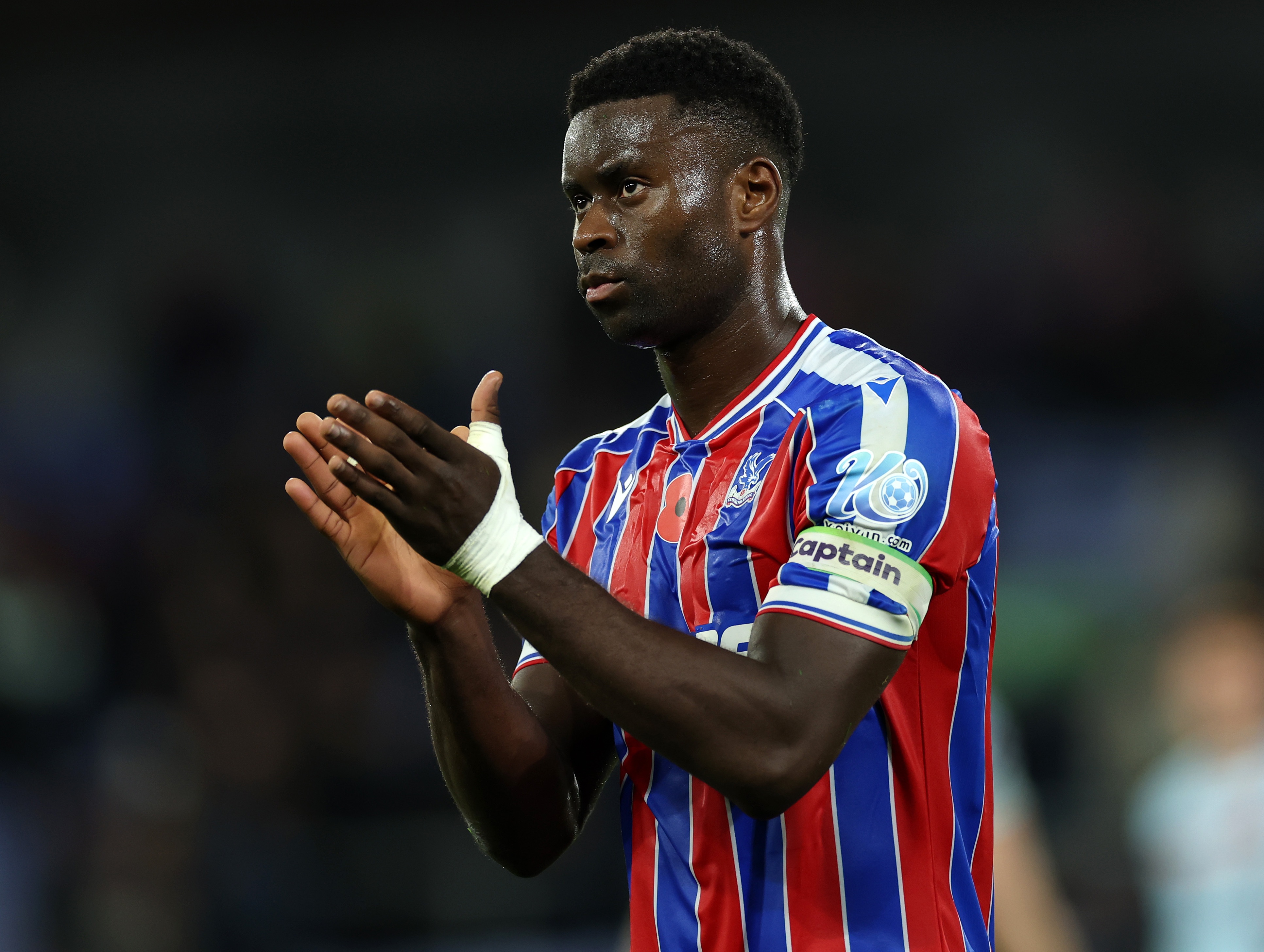 Crystal Palace defender Marc Guehi claps his hands.