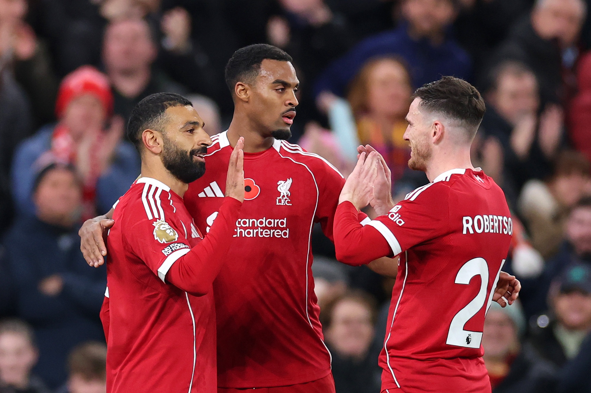 Mo Salah high-fives Andy Robertson during Liverpool game.