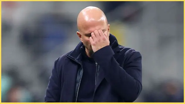 Arne Slot scratches his face at the San Siro.