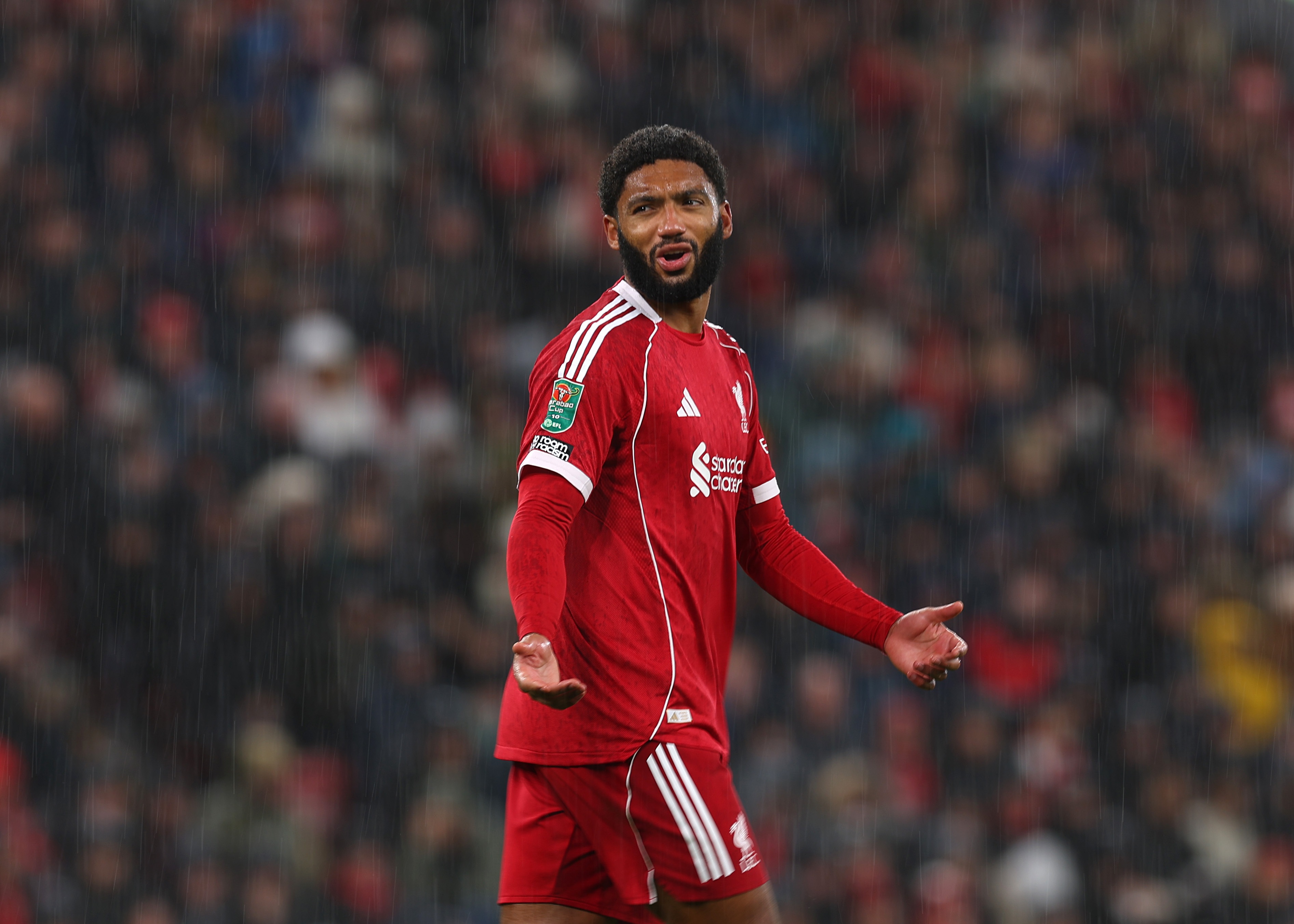 Joe Gomez gestures with his hands during Liverpool game.