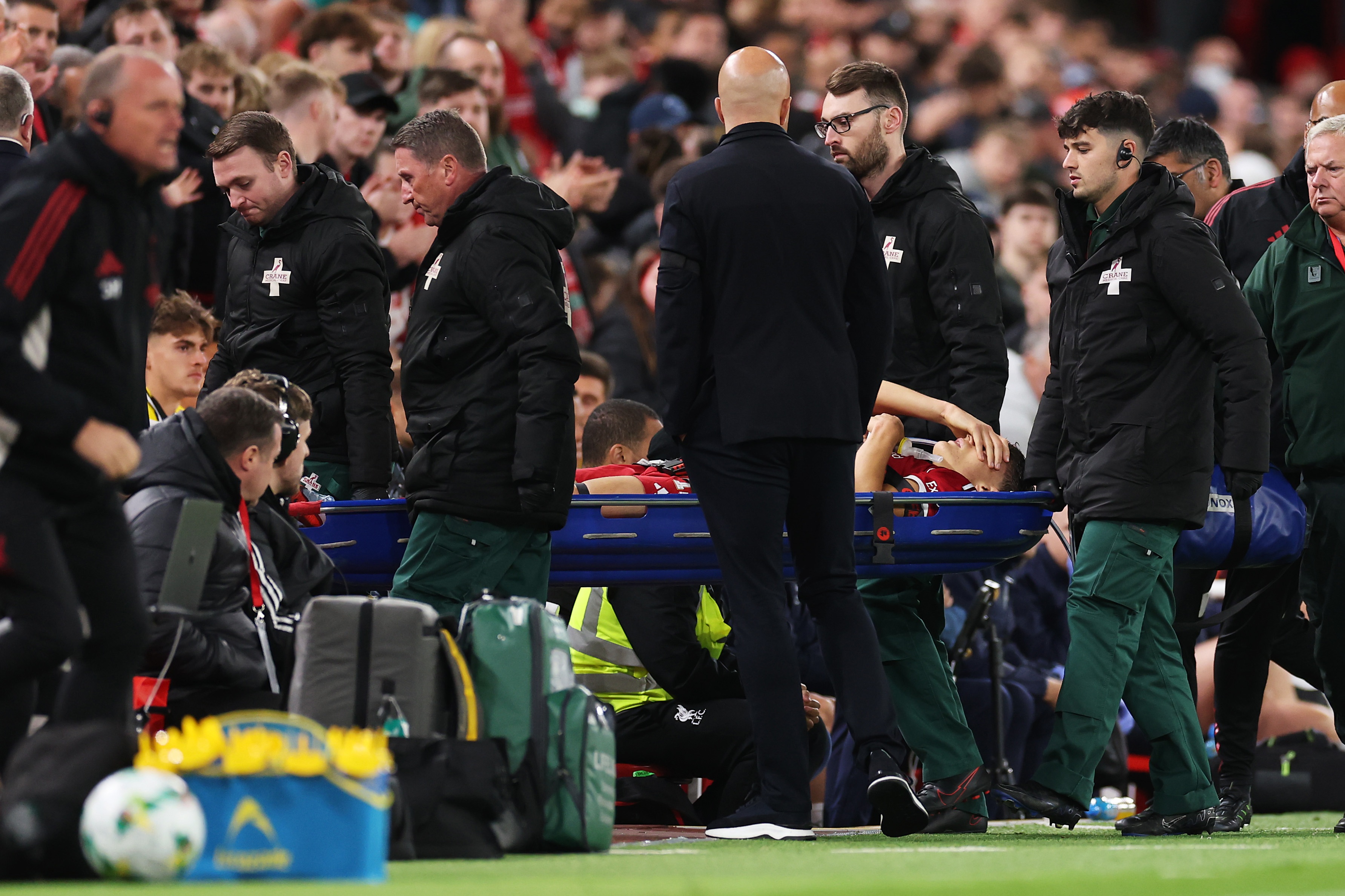 Giovanni Leoni is stretchered off the pitch with his head in one hand.