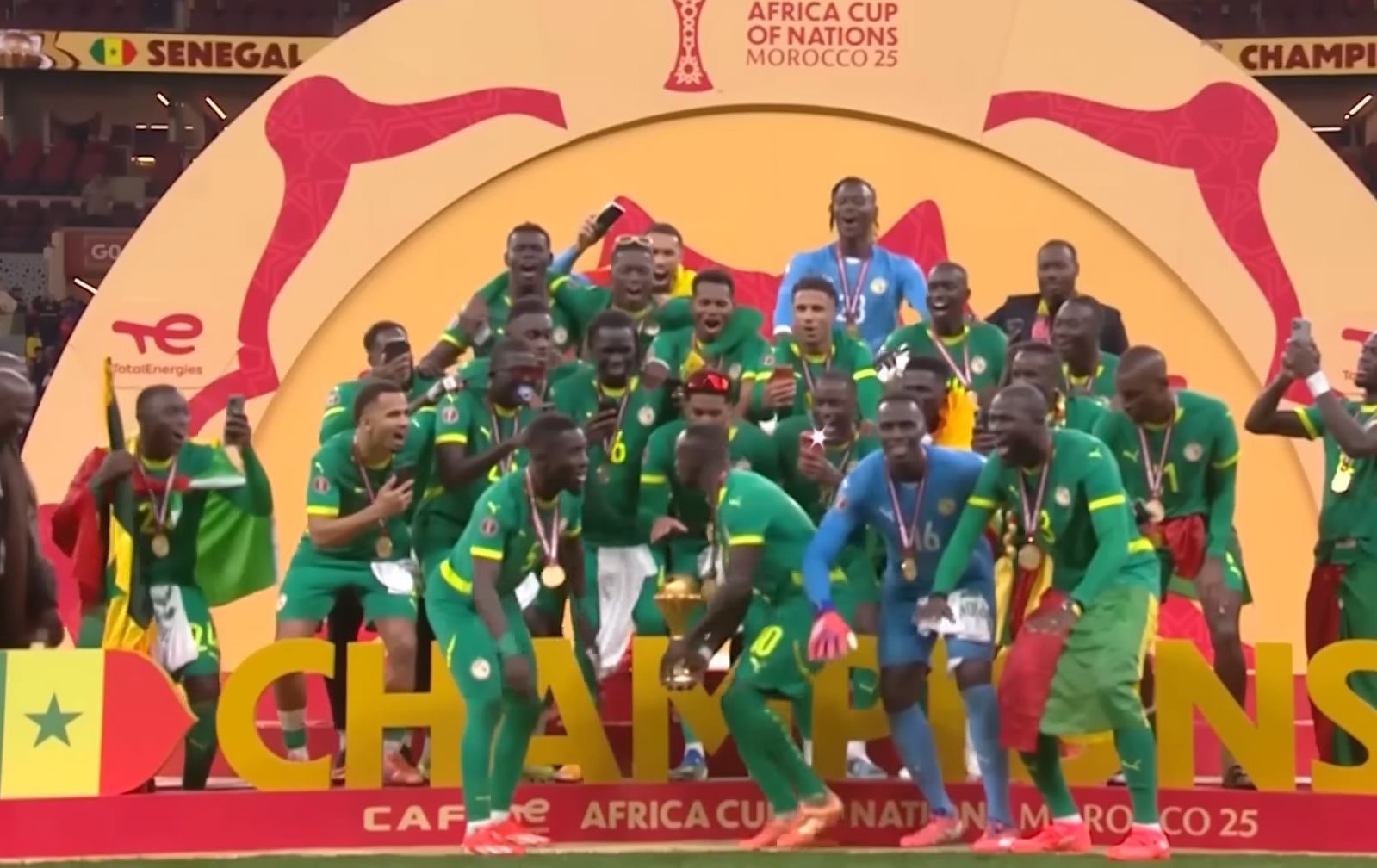 Sadio Mane turns to face his Senegal teammates as he lifts the Africa Cup of Nations trophy