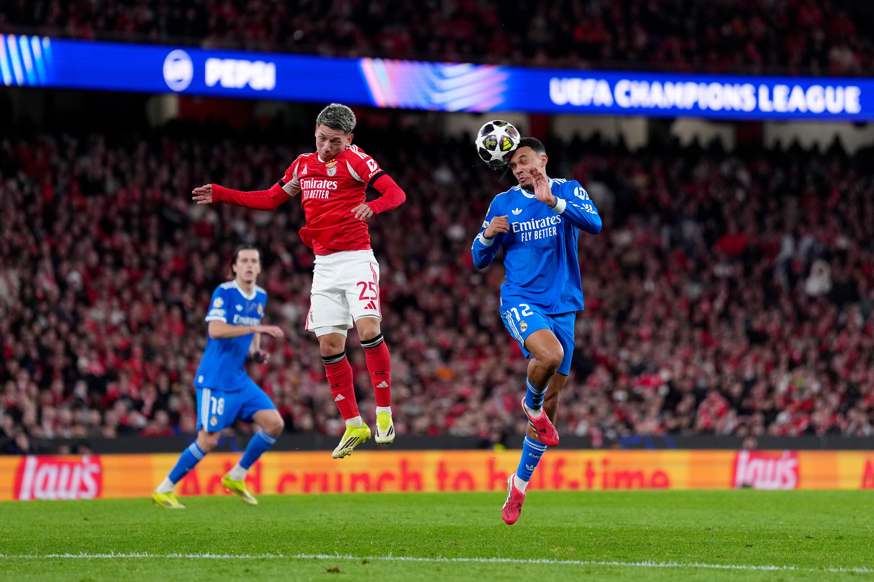 Trent Alexander-Arnold and Gianluca Prestianni jump for the ball.