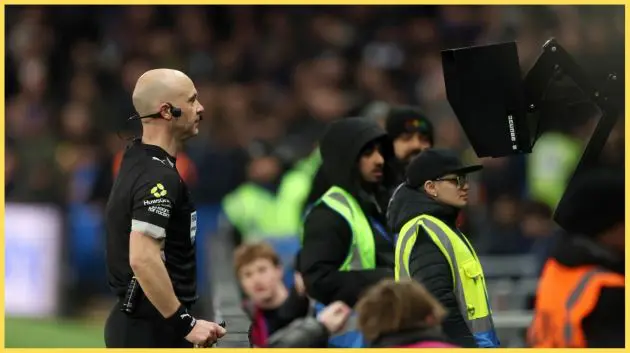 Anthony Taylor reviews a decision on the pitchside VAR monitor