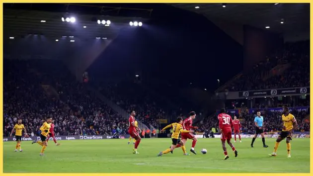 General view inside the stadium as Curtis Jones of Liverpool runs with the ball whilst under pressure from Hugo Bueno of Wolverhampton Wanderers