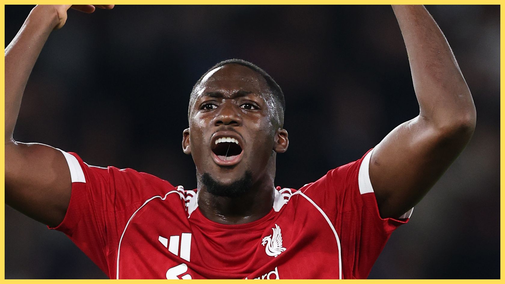 Ibrahima Konate screams and throws his arms up during Liverpool game.