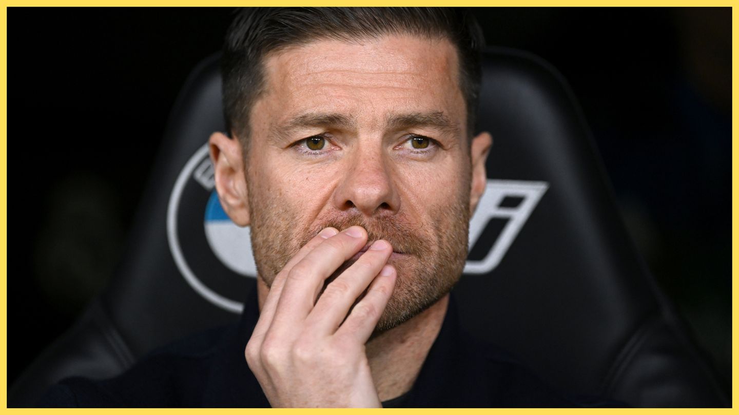 Xabi Alonso covers his mouth with his hand during Real Madrid game.