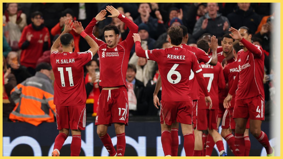 Mohamed Salah of Liverpool celebrates with teammate Curtis Jones after Hugo Ekitike scored his team's second goal during the Premier League match between Liverpool and Brighton & Hove Albion at Anfield