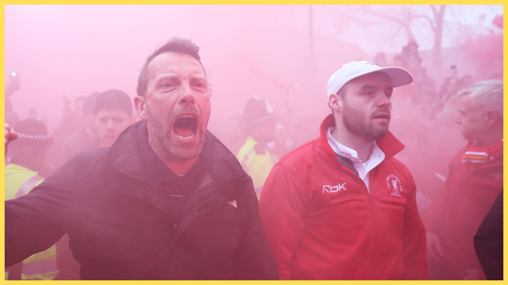 Liverpool fans march in red smoke ahead of PSG game.