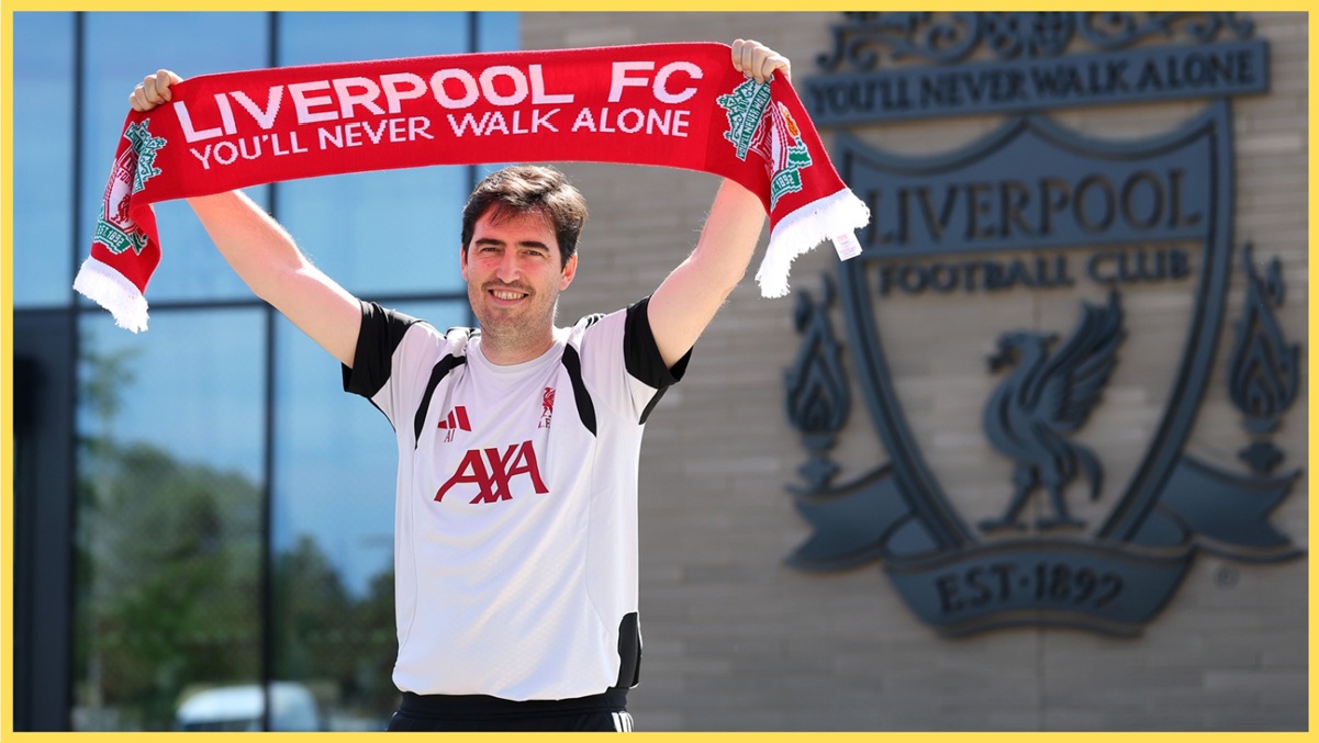 Andoni Iraola holds up a Liverpool scarf outside the AXA Training Centre