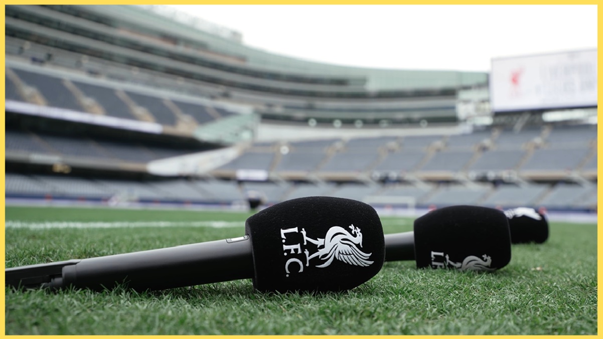 An LFC-embroidered microphone rests on the touchline