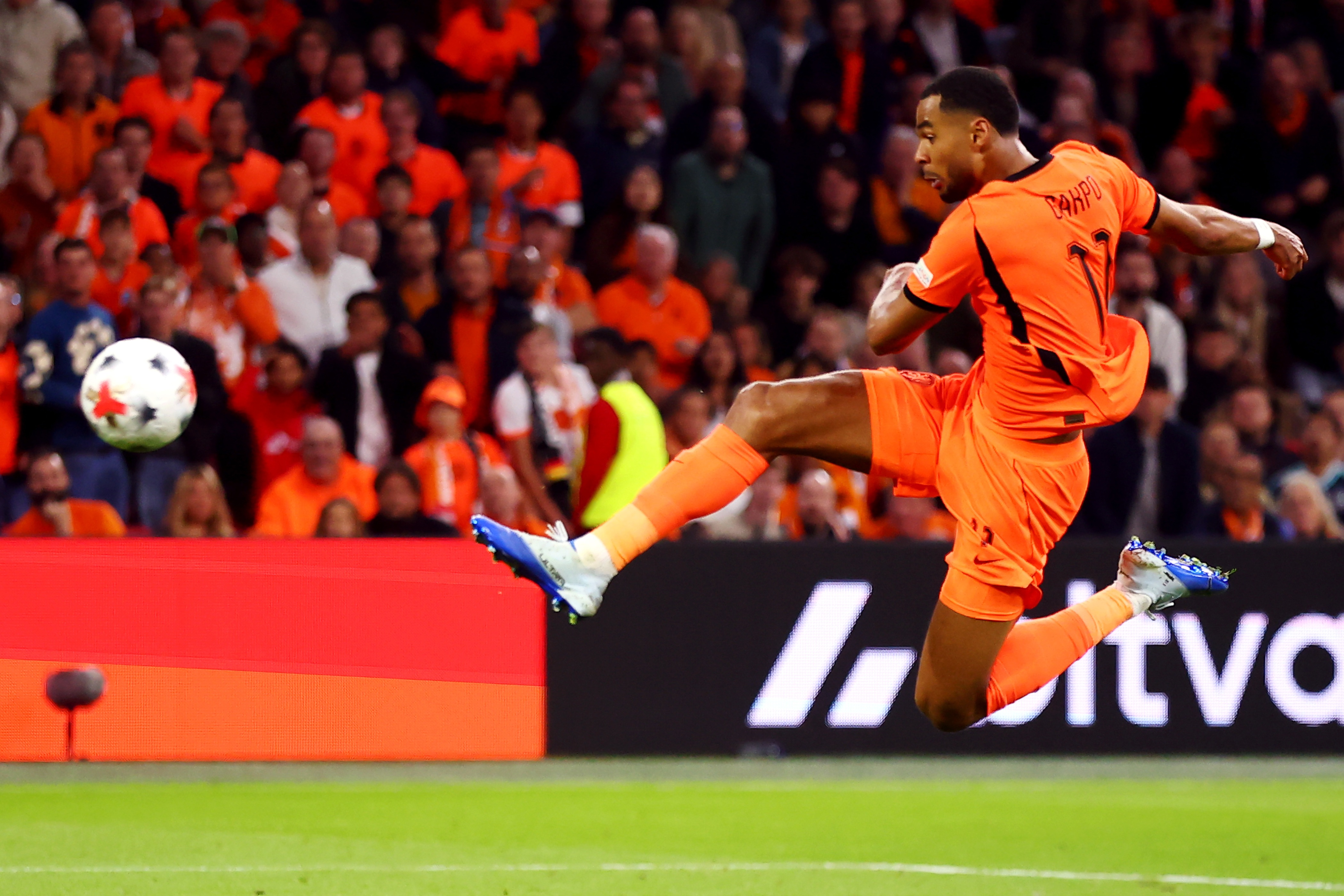 Liverpool winger Cody Gakpo acrobatically strikes a ball during Netherlands game.