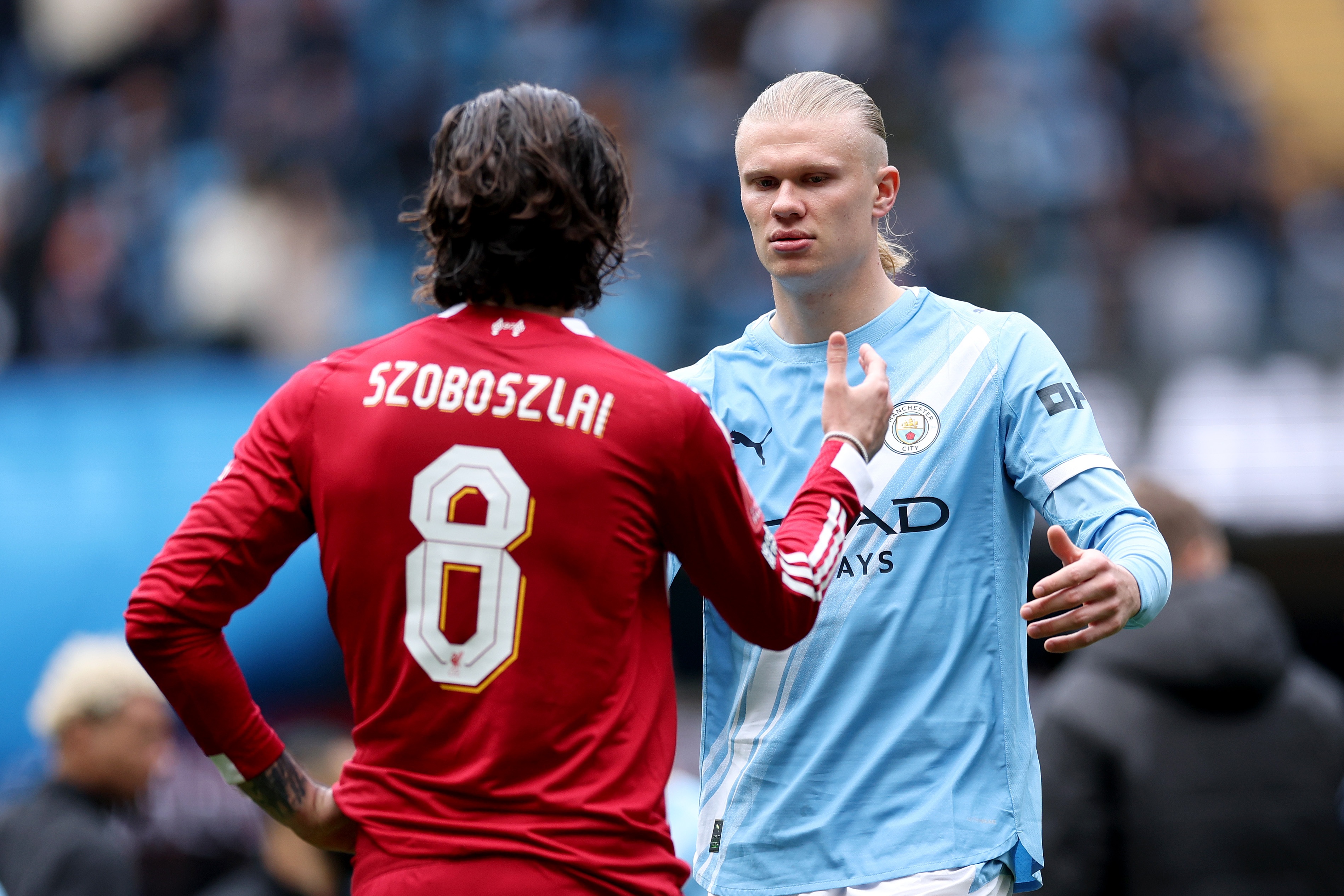 Manchester City striker Erling Haaland shakes hands with Liverpool midfielder Dominik Szoboszlai.