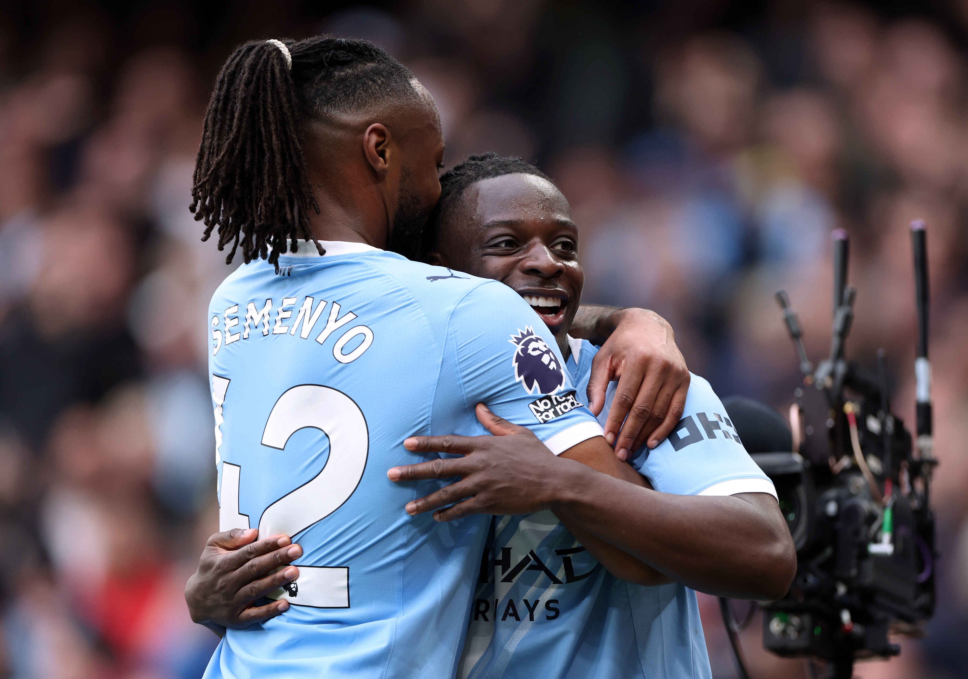 Antoine Semenyo hugs Manchester City teammate Jeremy Doku.
