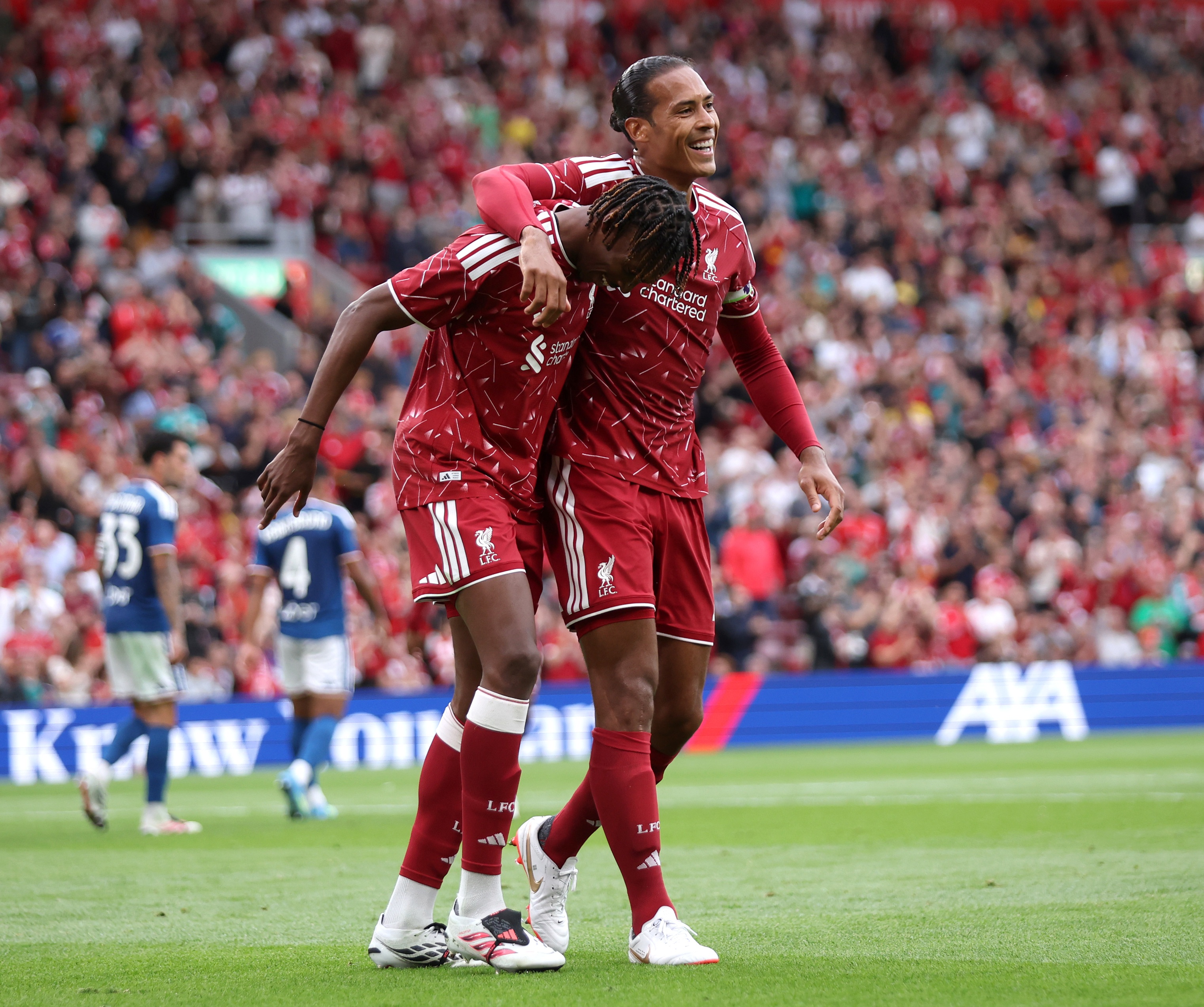 Virgil van Dijk puts his arm around Liverpool centre-back Jeremy Jacquet's shoulders.