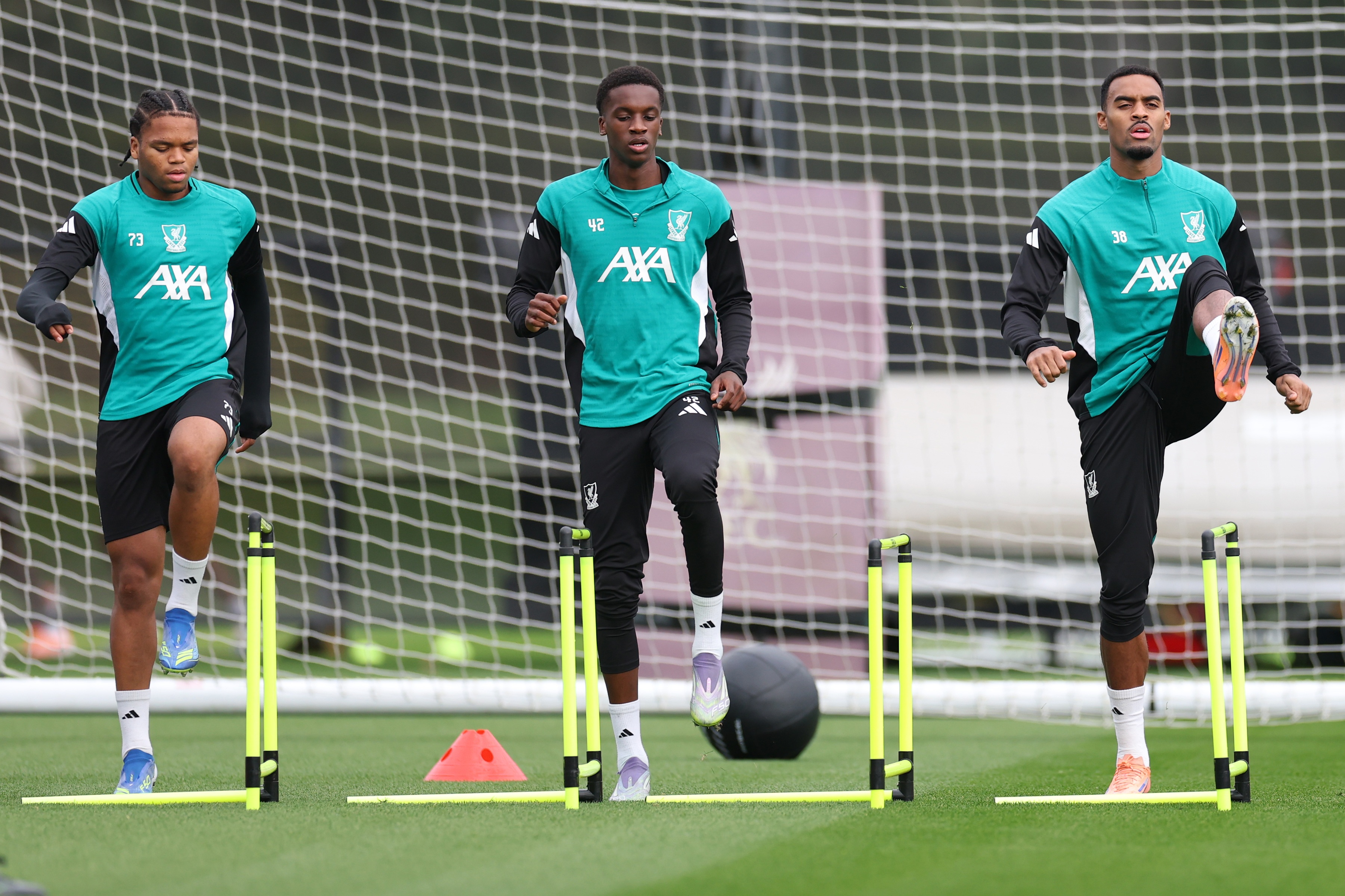 Liverpool midfielder Trey Nyoni warms up alongside Ryan Gravenberch and Rio Ngumoha.
