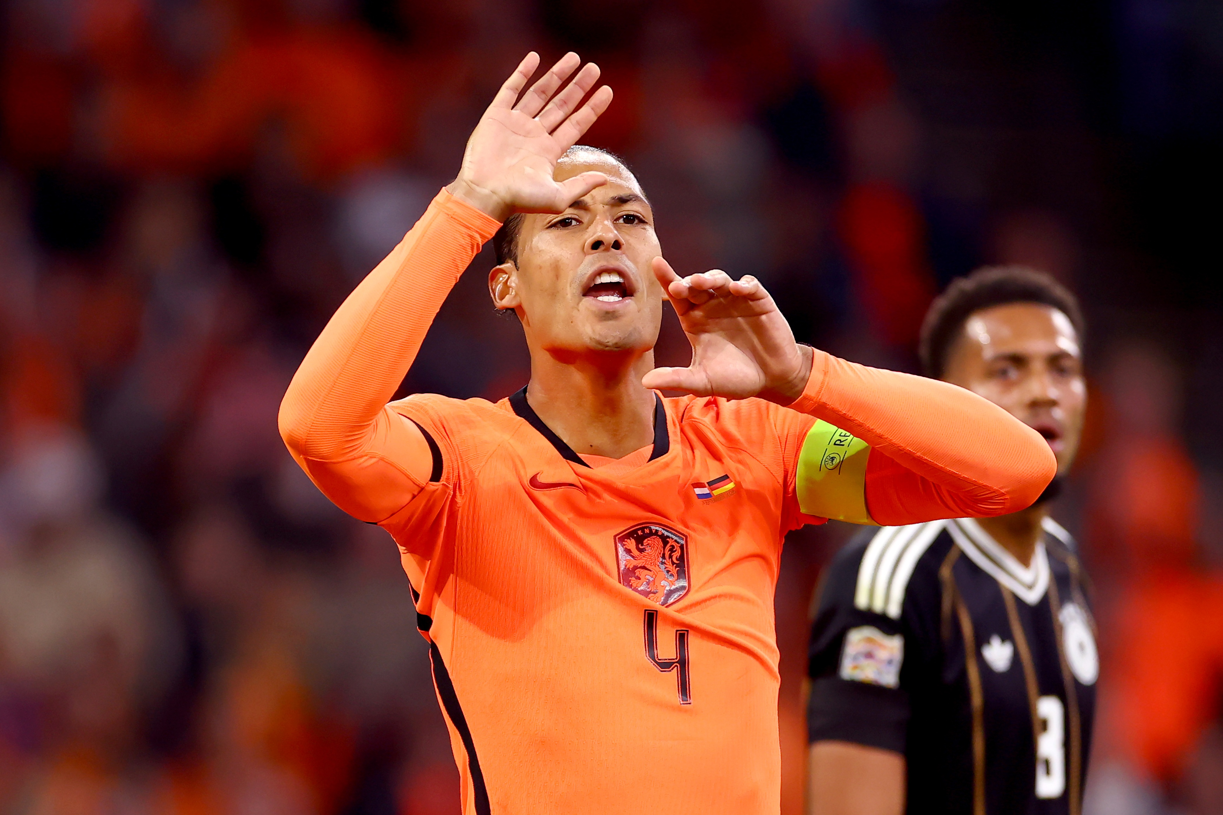 Netherlands defender Virgil van Dijk gestures and cups his mouth to shout.