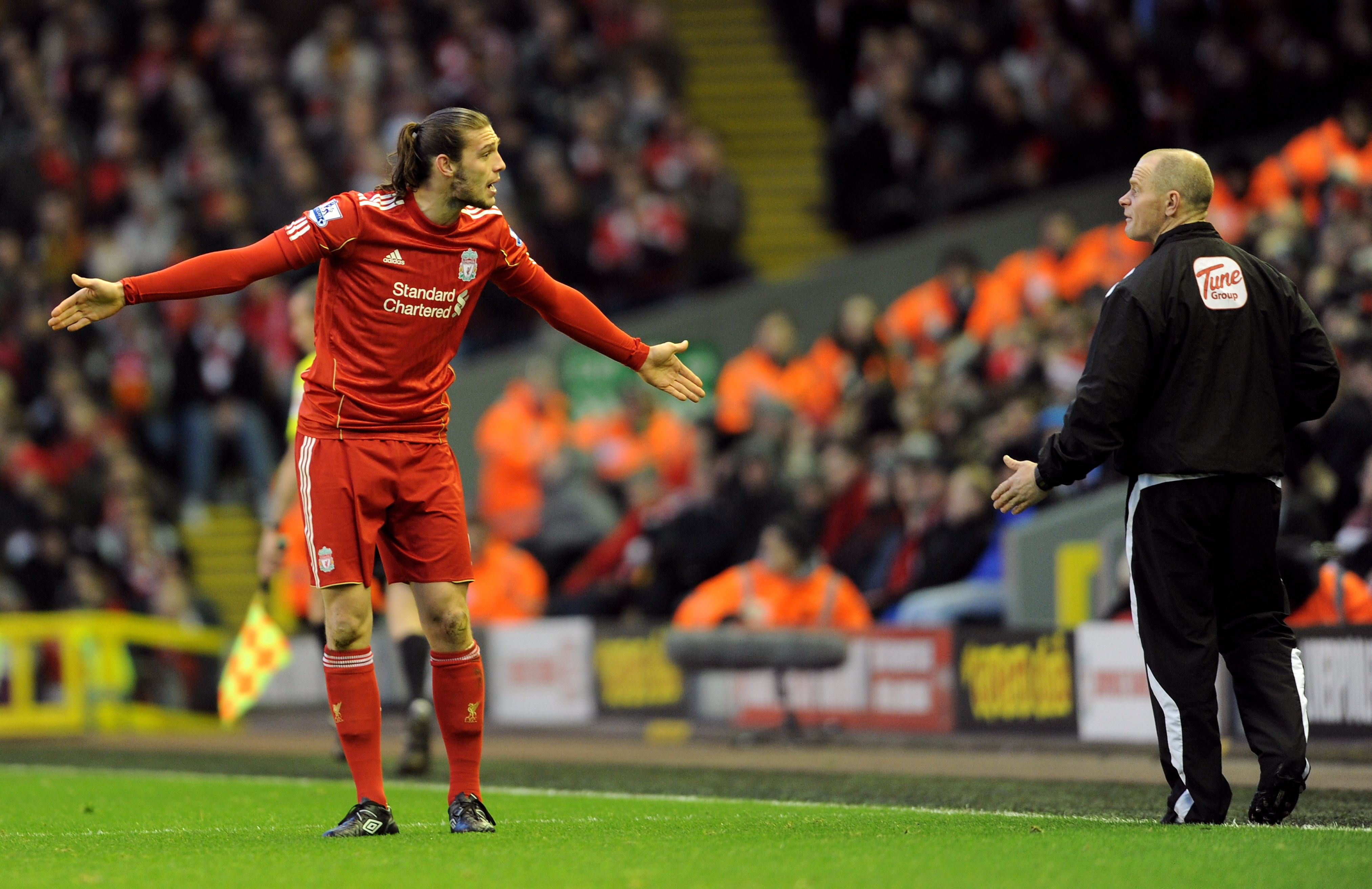 Andy Carroll protests to the fourth official during a match at Anfield