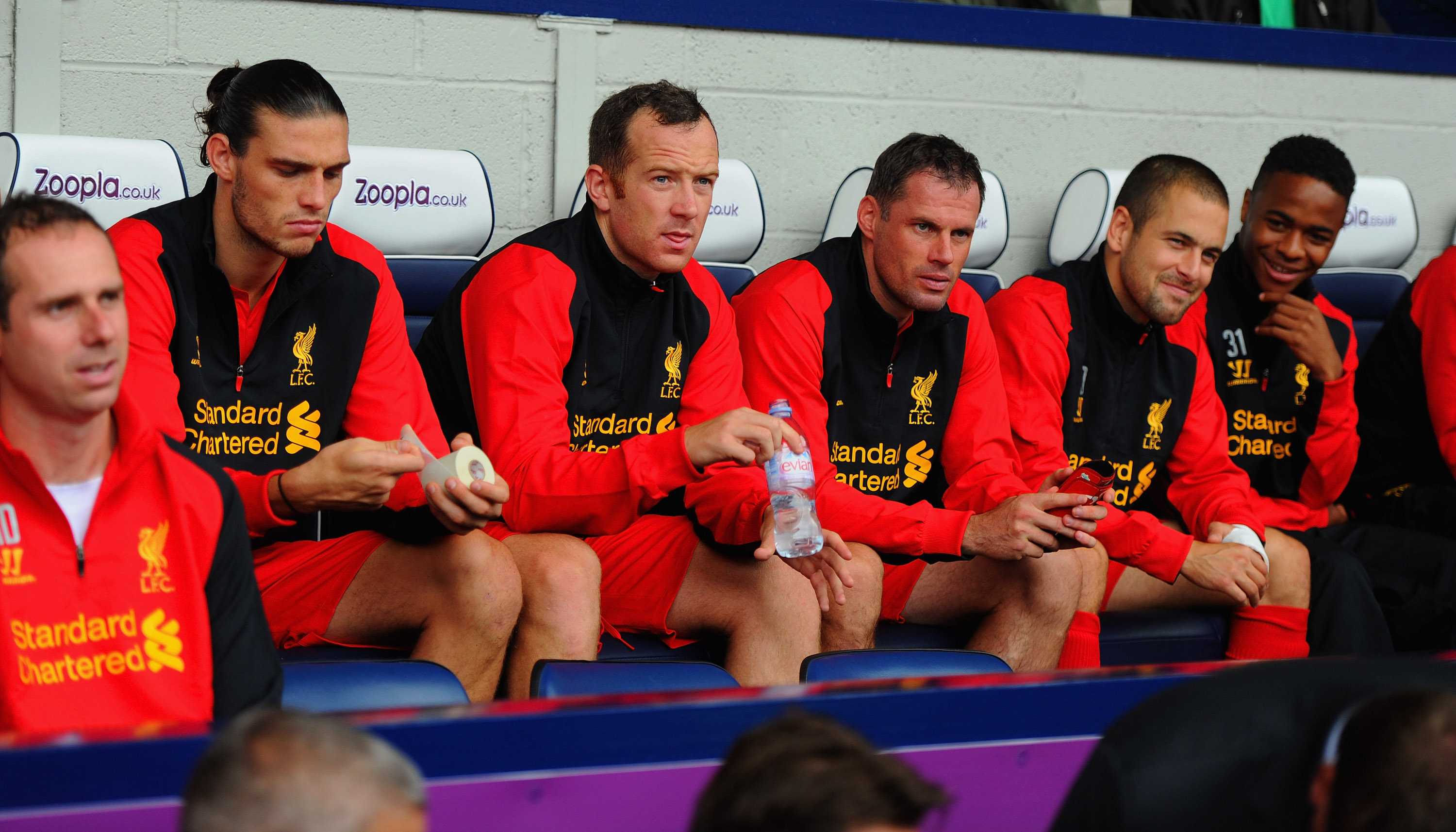 Andy Carroll, Charlie Adam, Jamie Carragher, Joe Cole and Raheem Sterling watch on from the substitutes' bench