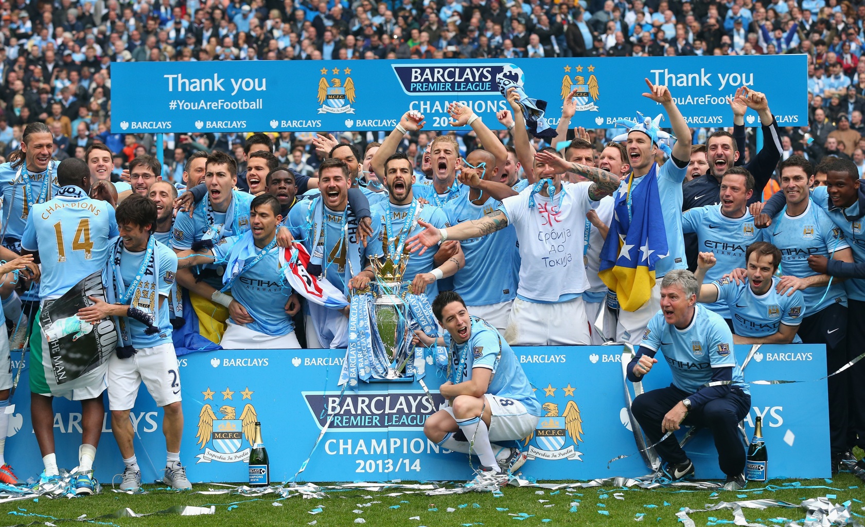 Manchester City players celebrate winning the Premier League in 2014